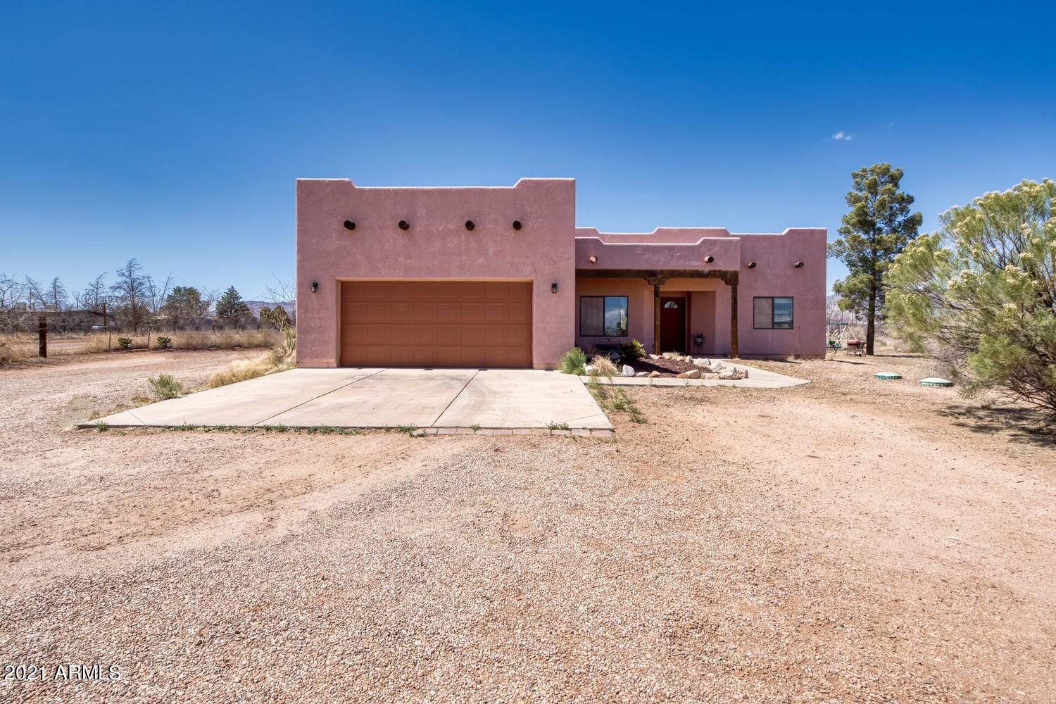 4 bed/2 bath 1860 sq ft Sante Fe style home on fenced one acre WITH adjoining 2 acre land being sold together as three acres.  This beautiful home exhibits a modern split floor plan, large kitchen with spacious bedrooms. Tile and wood throughout entire home. Extra large master contains  double sinks with walk in shower. Never miss a sunset from your extended back porch with serene waterfall. 2 acre parcel already has electric, septic, and private well.  Excellent opportunity to build a shop or guest home of your dreams. Property is fully fenced. Currently has one small additional home on land that can be removed if needed.  Minutes from Sierra Vista and Ft Huachuca, easy commute to Tucson. Enjoy country living at its finest.  
One of the sellers is a licensed agent in the state of Arizona