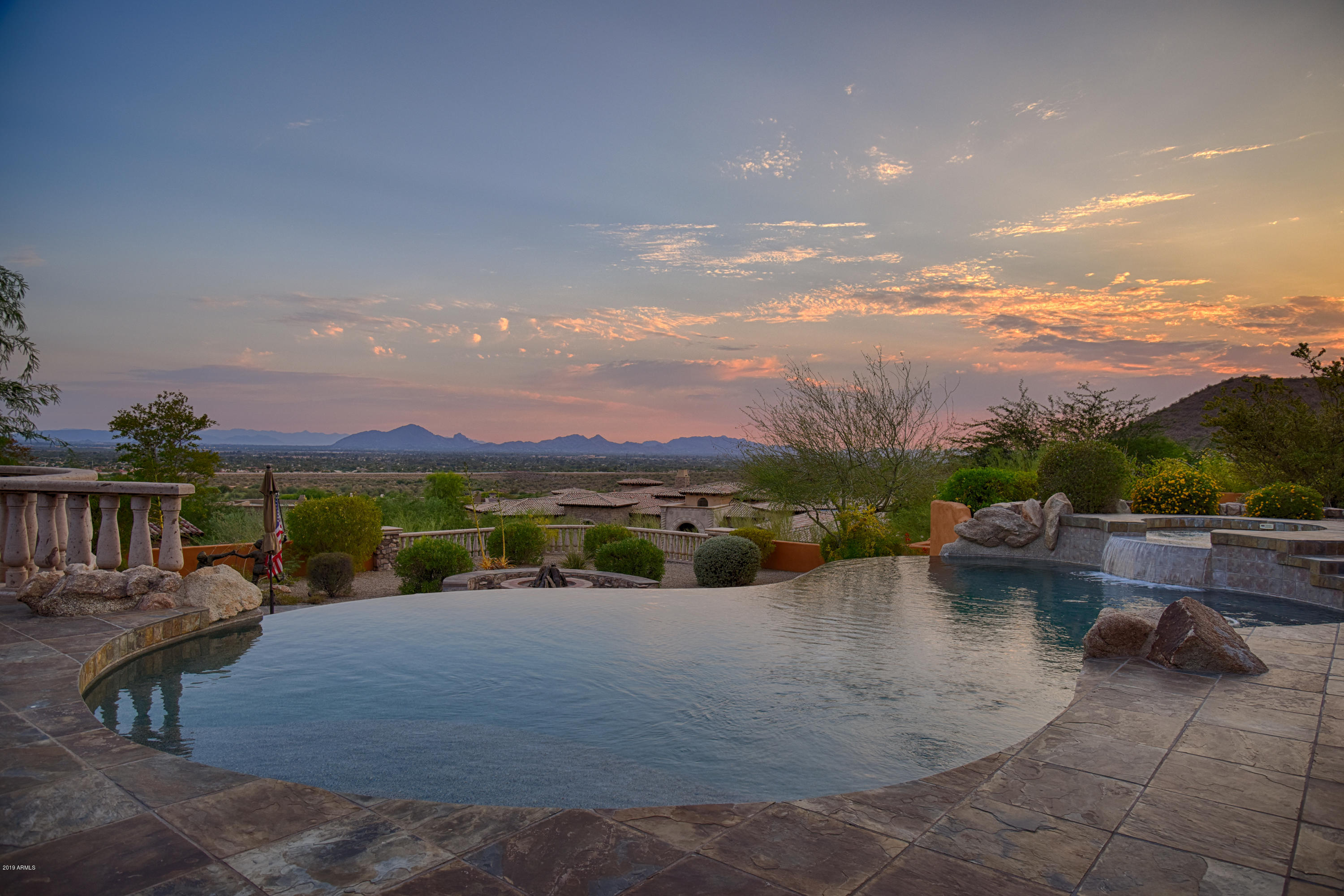 The Dreyfus Hill Estate. This ultra-custom single level entertainers home, was designed for luxury living and jet liner views. Located atop the prestigious 24-hour guard gated community of Ancala Country Club.  This is, the McDowell Mountains. Walls of glass with unobstructed Camelback Mountain and city views with stunning sunsets. Gourmet chef's kitchen, wine vault, theater, executive office, separate library, hotel bar and game room. Owners suite with rotunda sitting area, fireplace and designer closets. All bedrooms are en-suite. Infinity edge salt water pool and spa, covered patios, outdoor kitchen, fire pit, putting green and a detached one bedroom guest casita with kitchen. Close to hiking/biking trails, MAYO, Honor Health, BASIS, and top rated Scottsdale schools. No steps all views!