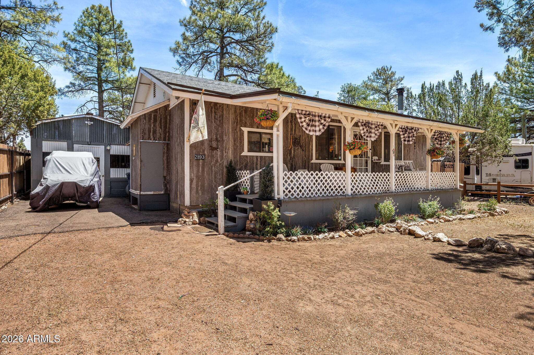 Escape to the mountains with this cozy 2-bedroom, 1-bath cabin tucked among the tall trees, offering privacy, charm, and plenty of potential. This quaint cabin features a covered front deck perfect for enjoying cool mountain mornings and peaceful evenings. A blacktop driveway provides easy access and added convenience year-round. The private backyard is perfect for relaxing, with towering pines, a seating area, and privacy fencing that creates your own secluded outdoor retreat. A detached shed/office offers flexible space for hobbies, storage, or a quiet workspace, while the numerous additional outbuildings can remain for extra functionality or be removed to create more open space. Inside, the home is ready for your personal touch and updates, making it a great opportunity to create the perfect mountain getaway, investment property, or full-time retreat.