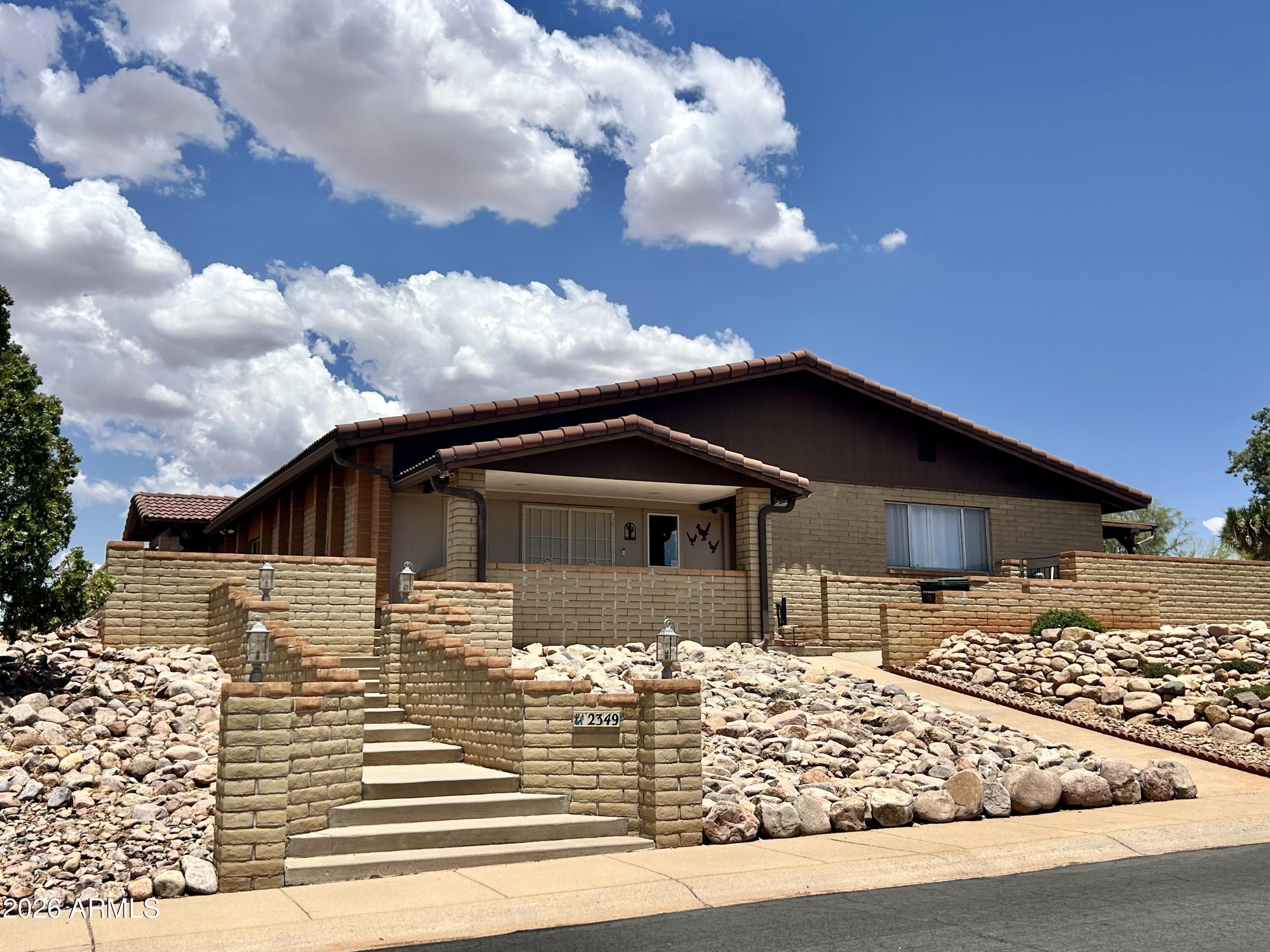 Near endless panoramic views of the Huachuca Mtns as well as views of Mule Mtns, Whetstone Mtns, and even Cerro San José, in Mexico from this private, elevated lot in the center of town! This spacious 5 bed 3 bath home offers, vaulted ceilings, open living areas flowing to the covered patio and private pool with built-in spa on a 0.67-acre fenced corner lot in the desirable Town & Country neighborhood.

The primary suite features two large closets, double-sink bath and patio access. Bedrooms 2, 3 & 4 offer ample room with large closets for plenty of storage. The versatile 5th bedroom features a full bath, two closets, a separate entrance and close access to the pool. The large eat-in kitchen offers Corian counters an island and plenty pantry space. Don't miss this gem! 

Agent/Owner