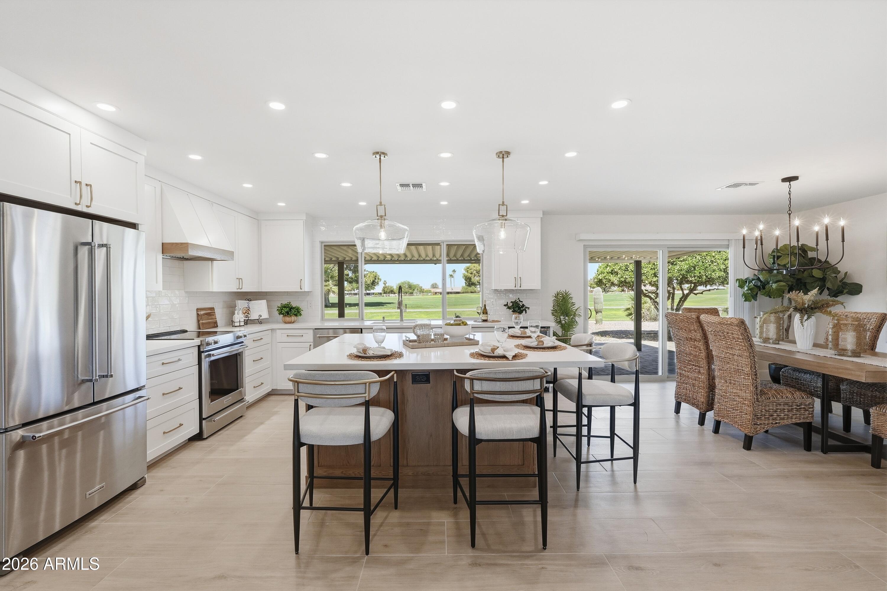 Stunning Golf Course Retreat! This exceptional recent renovation is truly beyond comparison, showcasing a thoughtful blend of functionality, style, and attention to detail! Flowing great room plan w/ fireplace and tile flooring. Open & bright kitchen features quartz counter tops, custom cabinets, KitchenAid appliances, & large island perfect for entertaining. Two primary suites and a powder room, providing space and privacy. Third bedroom can also be utilized as a home office. Custom vanities and tile showers add a touch of elegance.  LED recessed lighting and ceiling fans throughout the home enhance the modern design. Inside laundry w/ cabinets. Stucco exterior, dual pane windows & drs., HVAC-'26, 2 car garage, & golf cart garage. Inviting covered patio to enjoy the views! This is a 10!