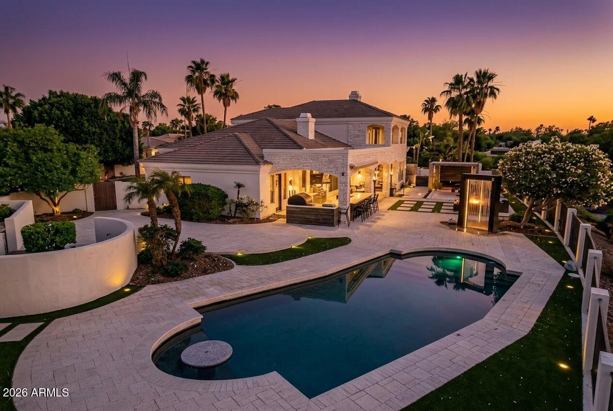 Set within one of Ocotillo's most desirable gated communities, this luxury estate sits on a private, elevated cul-de-sac with impressive curb appeal. The light-filled open floor plan is designed for everyday comfort & entertaining. The chef's kitchen features dual sinks, two dishwashers, double ovens, a warming drawer, oversized pantry, & coffee bar. A full bar with wet sink and ice maker opens through panoramic doors to a resort-style backyard. The private primary retreat includes a fireplace, steam shower, & a balcony with mountain, golf course, & community views. Additional highlights include a home gym, finished basement with guest living space, dual laundry rooms, & an entertainer's backyard with pool, waterfalls, fire features, & outdoor kitchen.