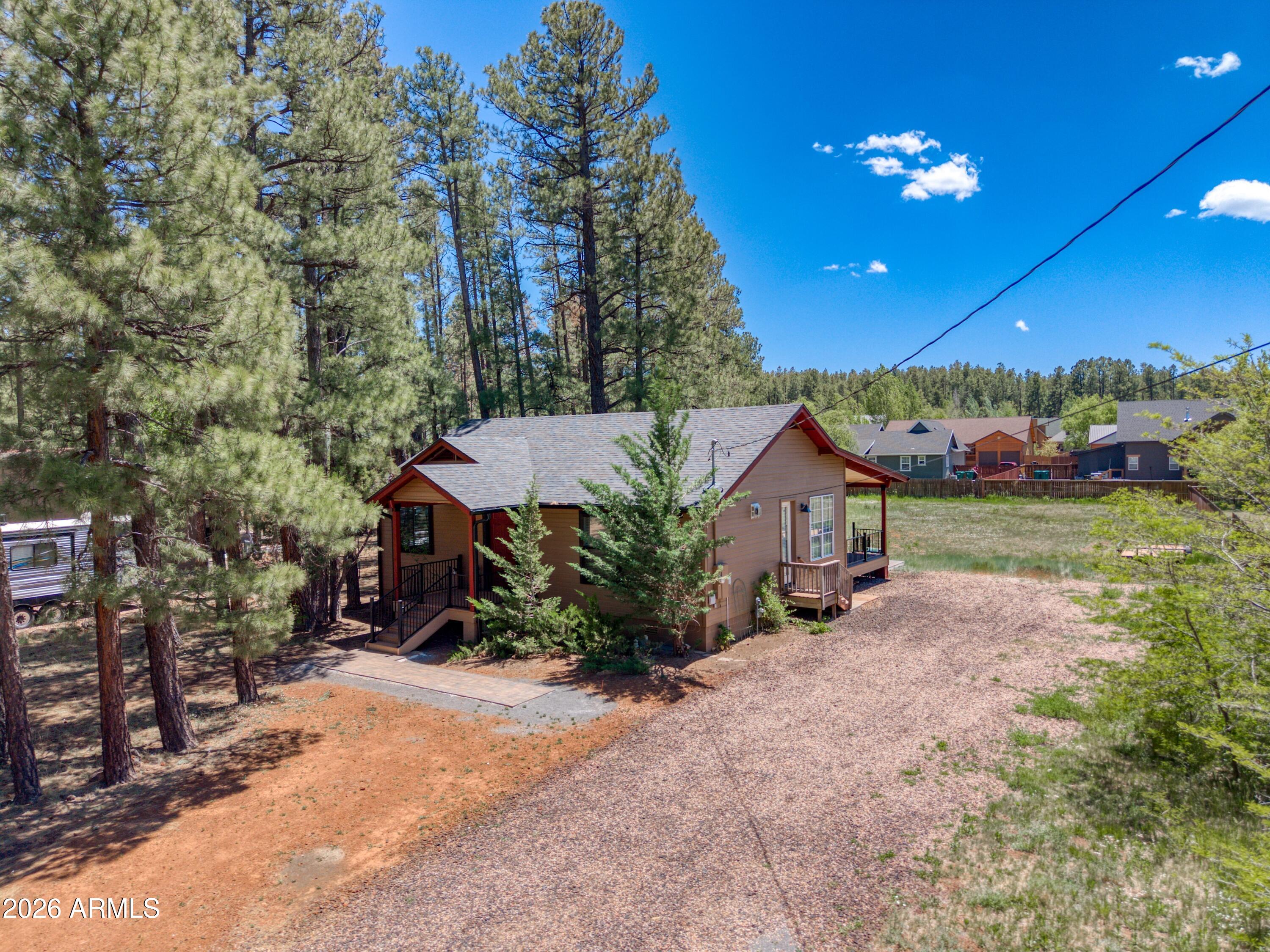 Tucked beneath the whispering pines near, this charming mountain hideaway feels like the kind of place where mornings begin slowly with coffee on the porch and evenings end beneath a sky full of stars. Set on .57 acres with no HOA, this beautifully renovated 2-bedroom, 1-bath home blends warmth, simplicity, and modern mountain style in all the right ways. Natural light pours through dual-pane windows, illuminating the inviting living spaces, updated flooring, and thoughtfully refreshed kitchen featuring quartz countertops, a gas range, and modern finishes that make the home feel both cozy and refined. Every corner invites you to relax, unwind, and imagine life at a different pace. For those dreaming even bigger, the property offers an incredible addition opportunity. READ MORE!!!! Plans are available for a 26x26 oversized garage plus 676 additional livable square feet, creating a full-size laundry room with mud sink, storage closet, spacious primary suite, walk-in closet, and full bath. Once completed, the home transforms into a stunning 1,911 sq ft, 3-bedroom, 2-bath retreat with an oversized garage -- all on .57 acres with no HOA -- offered at $634K. Whether you're searching for a peaceful full-time residence, a weekend escape, or a mountain investment with room to grow, this property captures the magic of Pinetop living the moment you arrive.