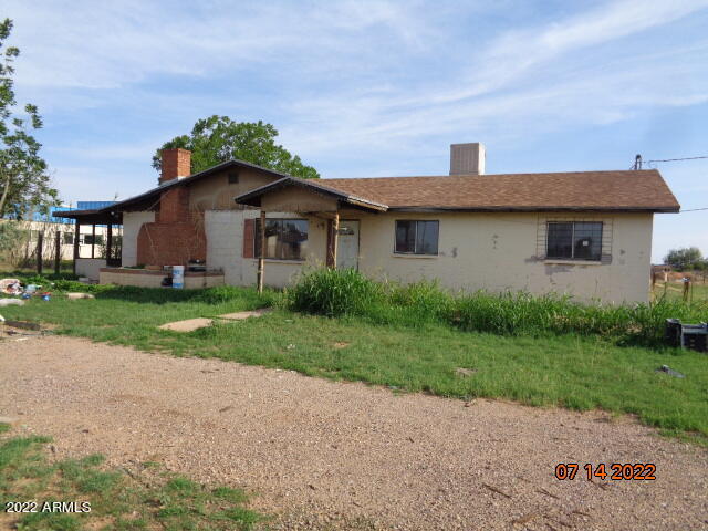 Here is a great opportunity for a large home at a great price in this market. This home has 4 bedrooms and 2 baths. There is a large family room with a wood burning fireplace. There is a covered patio off the family room too. The private well has a newer pump. There is a detached 2 car garage too. All this on a fully fenced acre.  Cash only offers please. This is an AS IS sale.