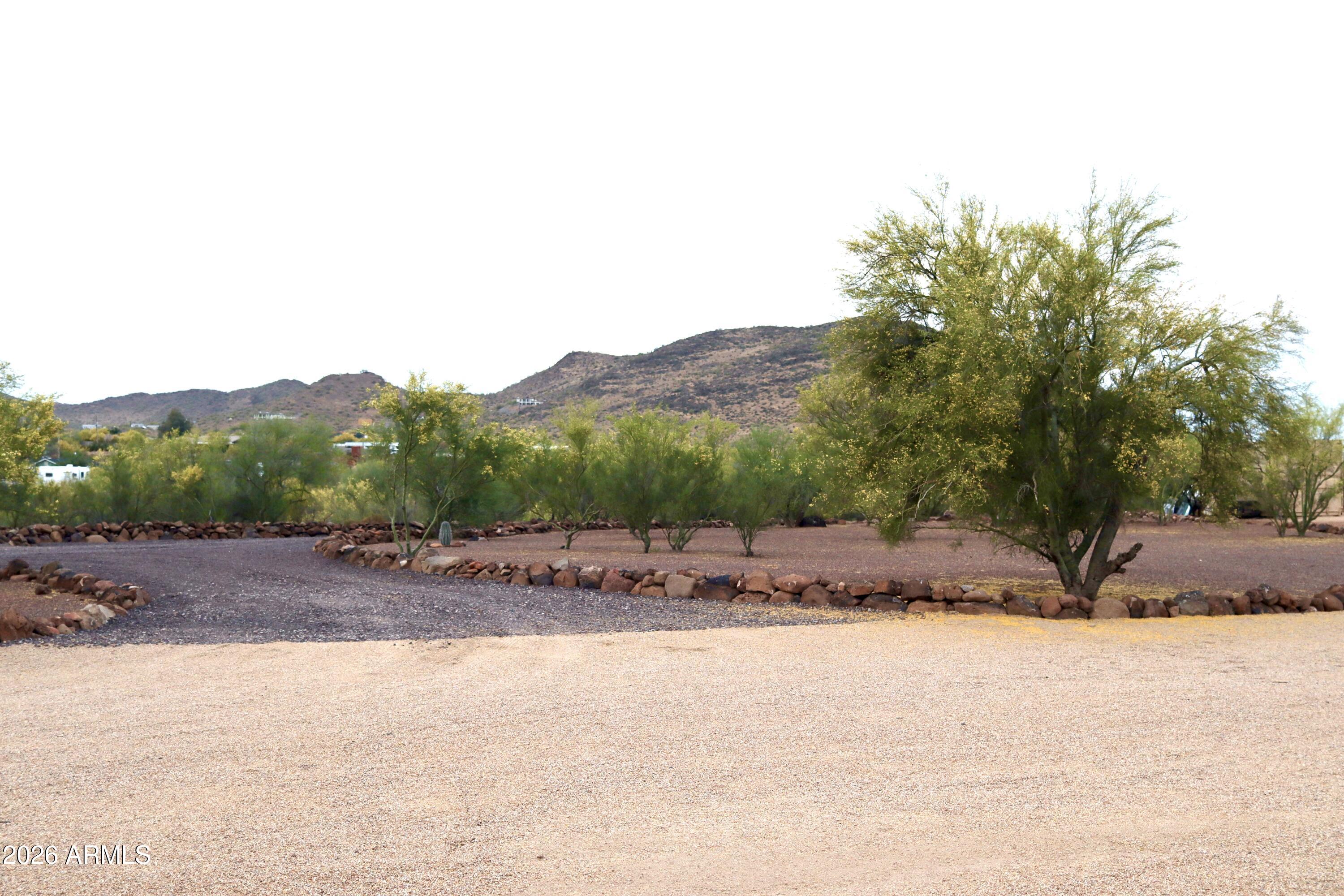 1.77 Acre Custom Home Lot in the Desert Hills/New River area with a shared well and  large building envelope.  Build or hold for future investment. Must see to truly appreciate the views!  Bring your toys, horses and vision.  Cline Creek on the East edge of the property creates a buffer to the East and provides spectacular elevated views of New River Mesa, Tonto National Forest and other mountains.  Survey, Shared Well Agreement (3 shares on the well)  and other info located in the documents tab.  Insulated 10'x20' storage shed conveys with the property.  Lot has been meticulously landscaped.  The only thing missing is your dream home!  If you are looking for a lot in the Desert Hills/New River area do yourself a favor and check this one out