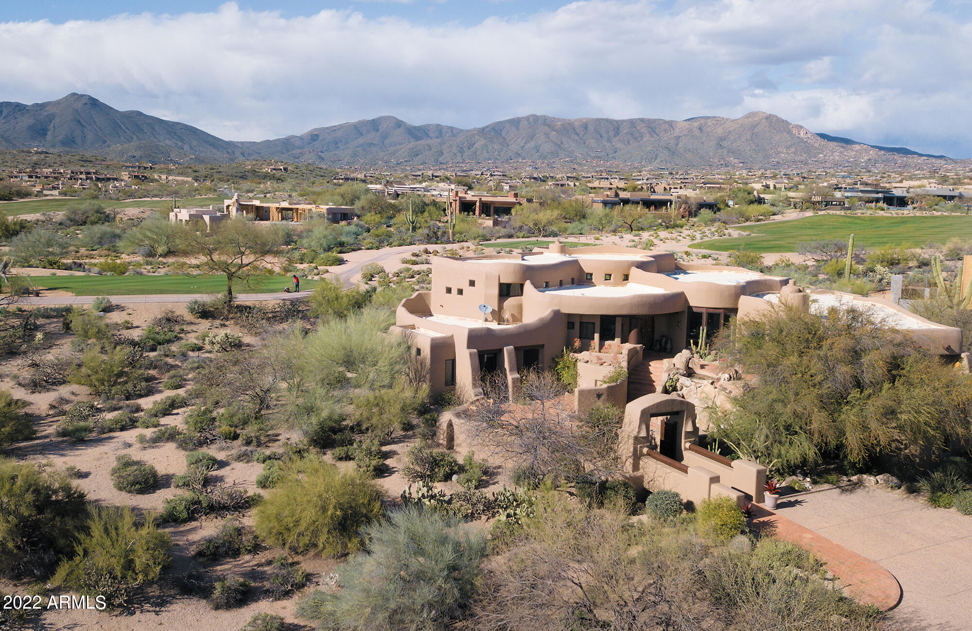 Never before on the market!  This classic Pueblo-style architectural showpiece in renowned Desert Mountain overlooks Renegade's 2nd fairway and magnificent Arizona sunsets. Offered turnkey with exquisite custom furniture, furnishings, and collectibles such as signed paintings and sculptural art of the Southwest's noted artists, all  highlighting the stunning features of the home. Beautiful bridge to welcome you, with gorgeous landscaping, unique entry patio and courtyard offering intimate seating, water fall and magical desert vistas. Desert Mountain Club golf membership IS available with this home... begin living the Desert Mountain Lifestyle immediately. with club approval and NO wait list. Elevator from lower level and garages; room to build a pool and guest house.