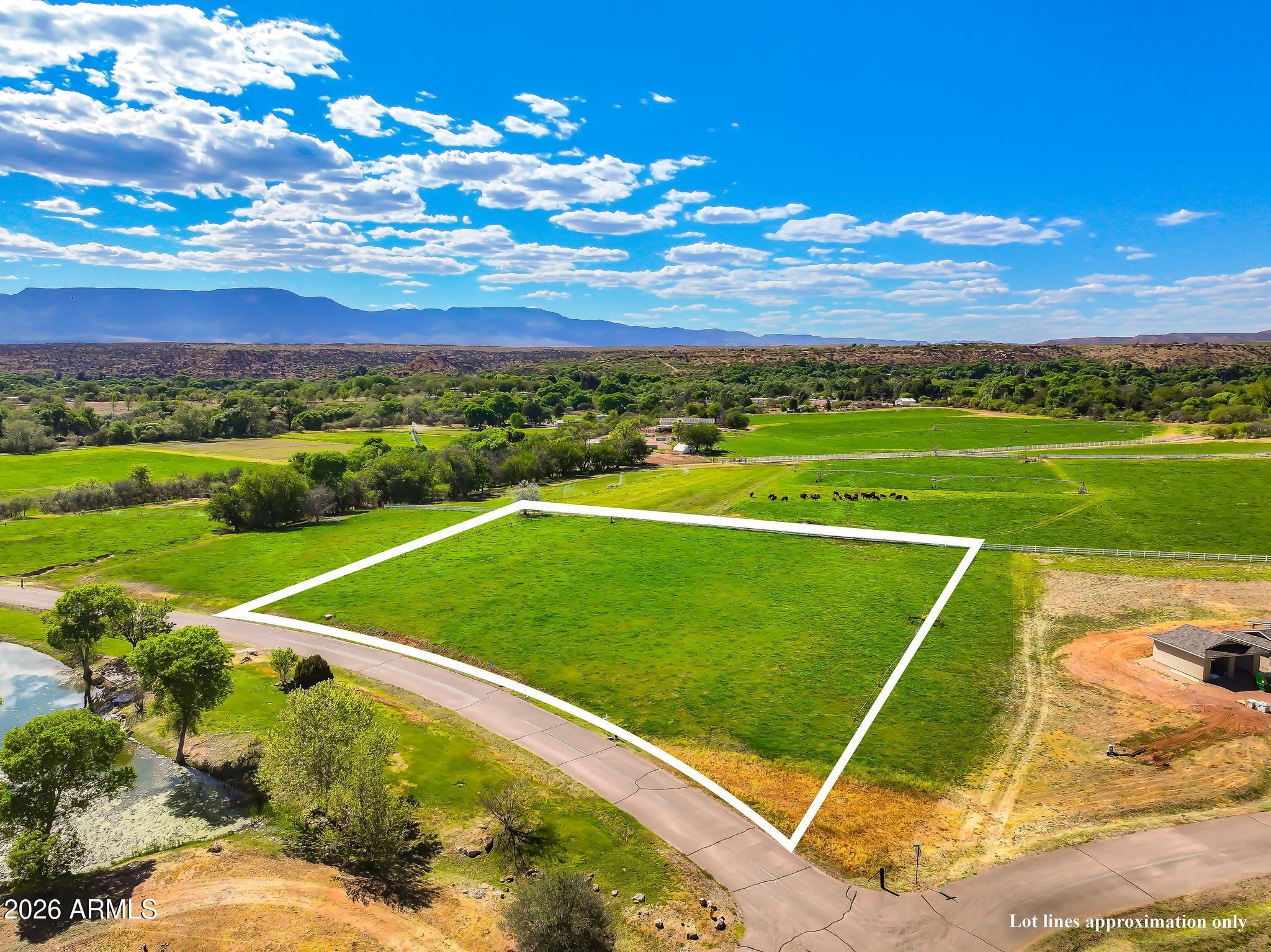 Beautiful IRRIGATED 2 acre lot in the highly desired Rio Bonito Ranch. This property has views of the mountains, the pond across the street, and behind it is a great view of the pastures of the bordering Tres Hermanas Ranch. Rio Bonito Ranch is a gated, quiet and serene neighborhood. It offers great amenities, like private access to Oak Creek, a stocked community pond, and the Mason Lane Ditch which wanders around the community like a small stream. The community also has well established water rights, incredible views and a lush green oasis feel spring and summer. Located about 20 minutes to West Sedona and 10 minutes to Cottonwood. Set a time to come check it out today!