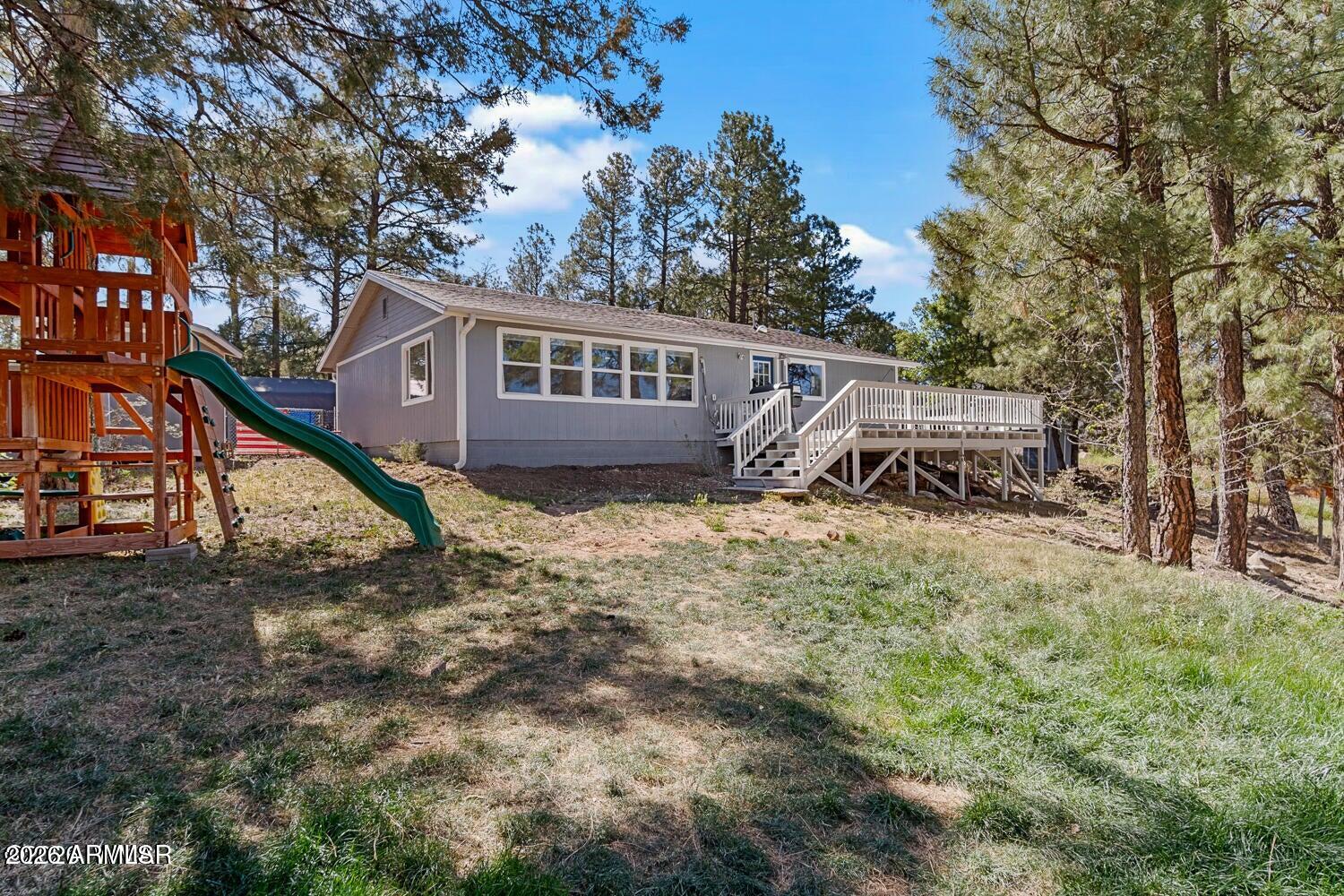 Tucked away at the end of a quiet cul-de-sac in Show Low, this updated site built home offers privacy, space, and a relaxed mountain feel with no HOA. Start your mornings on the front deck, taking in the fresh air and peaceful surroundings before heading inside to a bright, open layout that connects the kitchen, dining, and living areas. The living room really stands out with its panoramic views, bringing in natural light and giving the home an airy feel. The kitchen has been tastefully updated with a farmhouse sink and a clean, modern look, and the mini split systems, installed less than two years ago, keep the home comfortable year round. With 3 bedrooms and 2 bathrooms all on one level, the layout is simple, functional, and easy to live in. The primary suite is generously sized and features a walk-in closet and a soaking tub, creating a comfortable retreat. A separate mud room adds everyday convenience and functionality. Did we mention the roof is only a few years old?!
Out front, there is plenty of space for your dogs or kids to run around and enjoy, along with a separate fenced area specifically for pets, giving you flexibility and convenience.
The setting feels tucked away, but you are still just minutes from Fool Hollow Lake, Bison Golf Course, parks, shopping, and everyday essentials. Whether you are looking for a full-time family home or a second place to get away, this property offers comfort, space, and a great location without feeling remote.