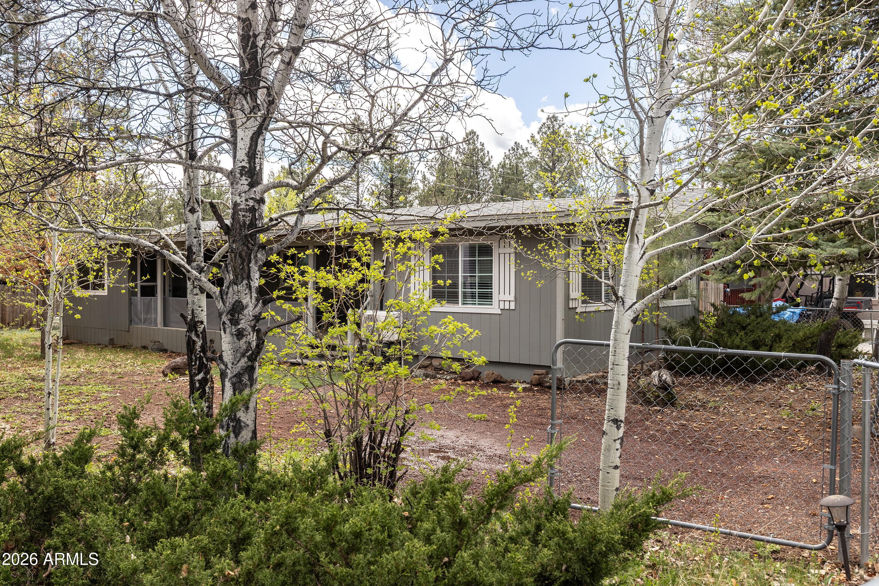 Nestled among the tall pines of Munds Park, this beautifully updated 3 bed, 2 bath home offers the perfect blend of comfort and mountain charm on a nicely sized lot. Inside, you'll find a thoughtfully updated interior with modern finishes while still maintaining a warm, inviting cabin feel. The spacious living area features a cozy fireplace, ideal for cool mountain evenings, while large windows bring in natural light and peaceful forest views. Step outside to a covered front porch perfect for morning coffee or unwinding after a day outdoors. The generous lot provides space to entertain, relax, or enjoy the fresh pine air. Whether you're looking for a full-time residence, weekend getaway, or investment opportunity, this home captures the best of Northern Arizona living in a highly desirable setting! Just a quick 4-minute drive to Pinewood Country Club, a well-known local favorite offering a variety of amenities including golf, a restaurant and bar, pool, kids club, pickleball, and a full calendar of community events. Enjoy nearby lakes, scenic trails, and easy access to the Coconino National Forest for endless outdoor recreation. Munds Park is ideally situated just 17 miles south of Flagstaff and only about a 2-hour drive from Phoenix making it the perfect escape from the summer heat.