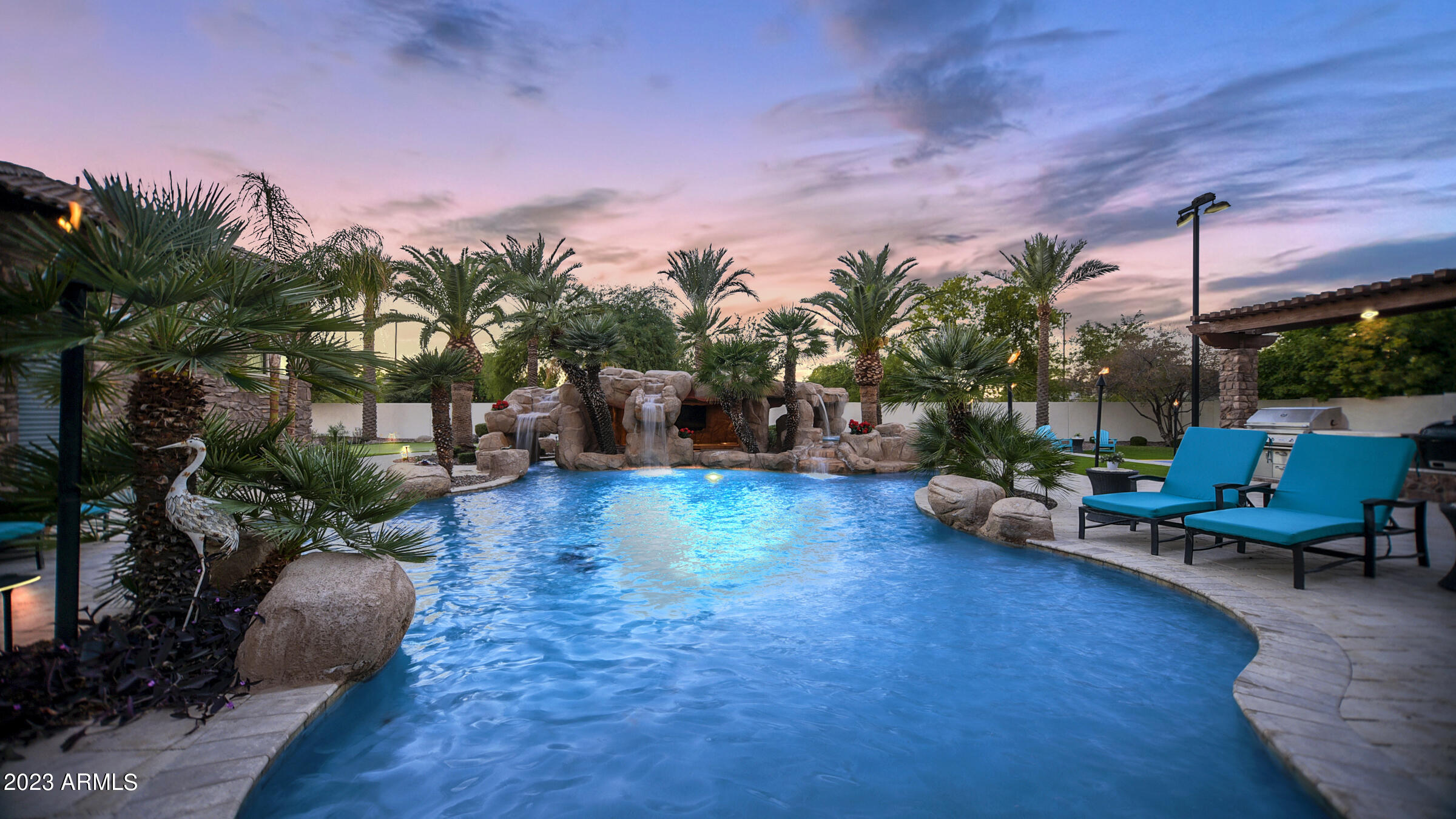 Discover this magnificent 7,960 sf Entertainer's Paradise Estate nestled behind the private gates of ESTADOS, Circle G, within the prestigious Seville Golf & Country Club. This sprawling single-level custom estate occupies a premium country club lot & features a 1,260 square foot poolside guest house perfectly positioned next to a luxurious, custom-designed multi-million-dollar pool complete with a massive bar grotto. The backyard resembles a five-star resort & elevates the ''swim-up bar experience'' to new heights, allowing you to swim through cascading waterfalls into an underwater Caribbean bar setting. This outdoor living space ranks among the finest in all of Arizona. However, don't be deceived, as the interior of this home is equally impressive. The floorplan is thoughtfully designed to showcase the outdoor living spaces & centers around a beautiful open-air courtyard with a welcoming fireplace that greets visitors as they step into the grand foyer. The chef's kitchen is a true masterpiece, featuring double islands & upgrades that even the most discerning chefs will appreciate. If hosting your very own movie premieres has always been a dream, look no further! This estate boasts one of the finest in-home movie theaters with a full bar, providing an unparalleled cinematic experience. Whether you're an avid entertainer or someone who enjoys cozying up in your resort-style yard, this exquisite custom estate will captivate you the moment you walk through the door. What's even more impressive is its proximity to Gilbert's only private country club, Seville Golf & Country Club. Here, you can enjoy an 18-hole golf course, four pools, two-story waterslides, a health club, pickleball & tennis courts, basketball courts, two restaurants, & much moreall just a short golf cart ride away. Come experience the luxurious lifestyle that this stunning estate has to offer.