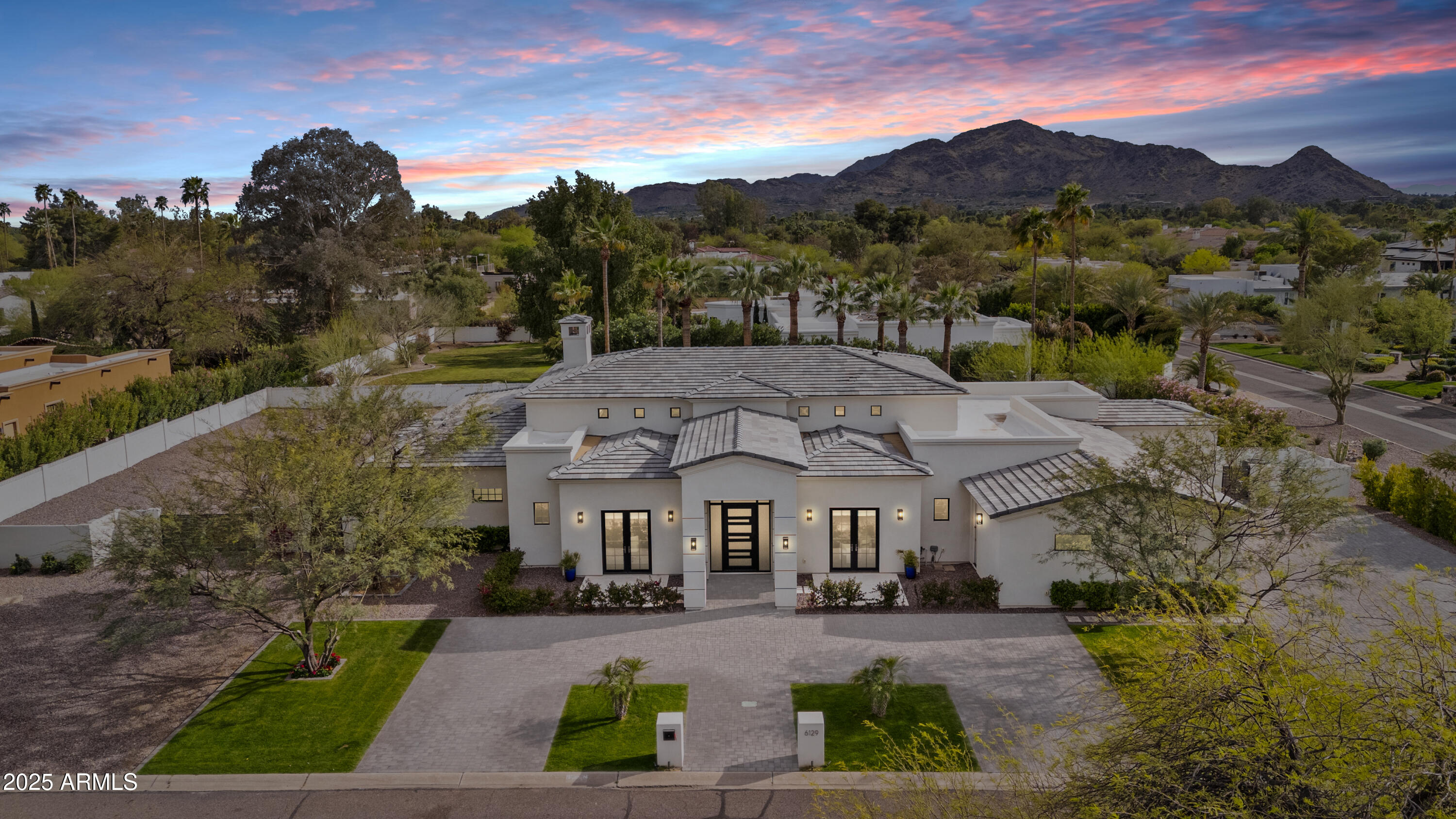 Modern one story soft contemporary.  Entering the home enjoy an airy feel with high ceilings and views of the beautiful backyard.  Open kitchen with top of the line Thermador appliances, two dishwashers, double ovens and wine refrigerator.  Four bedroom, split setup features separate sitting area for guest wing.  Large master suite. Backyard oasis has numerous palm trees, beautiful pool and Jacuzzi, separate waterfall, and firepit.  Additional RV gate and drive. Lot is large enough to accommodate a guest house.  Experience PV living at its best!