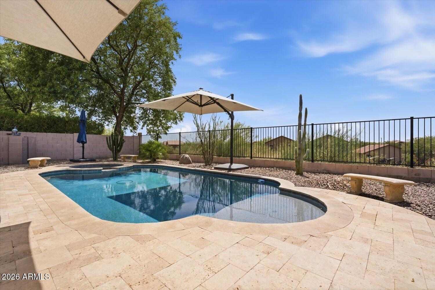 Pride of ownership shows in this single level 2,309 sq ft home offering 4 bedrooms, den, 2 baths & desert view! Step inside to a spacious living/dining room. Family room is open to the kitchen featuring Granite counter tops, island w/breakfast bar & pantry. French doors lead to a large master suite. Master bath has double sinks, separate tub/shower & walk-in closet. Split floorplan offers privacy from the 3 additional bedrooms and den makes for a great office. Step outside to a large covered patio, sparkling play pool & spa (2020) that are heated for year-round use and view fence w/no homes behind! Extra space in the laundry room & washer/dryer included. Assumable solar loan reduces monthly electric costs. HVAC 2024, Water Heater 2022. Great location w/easy access to the I17 & 303.