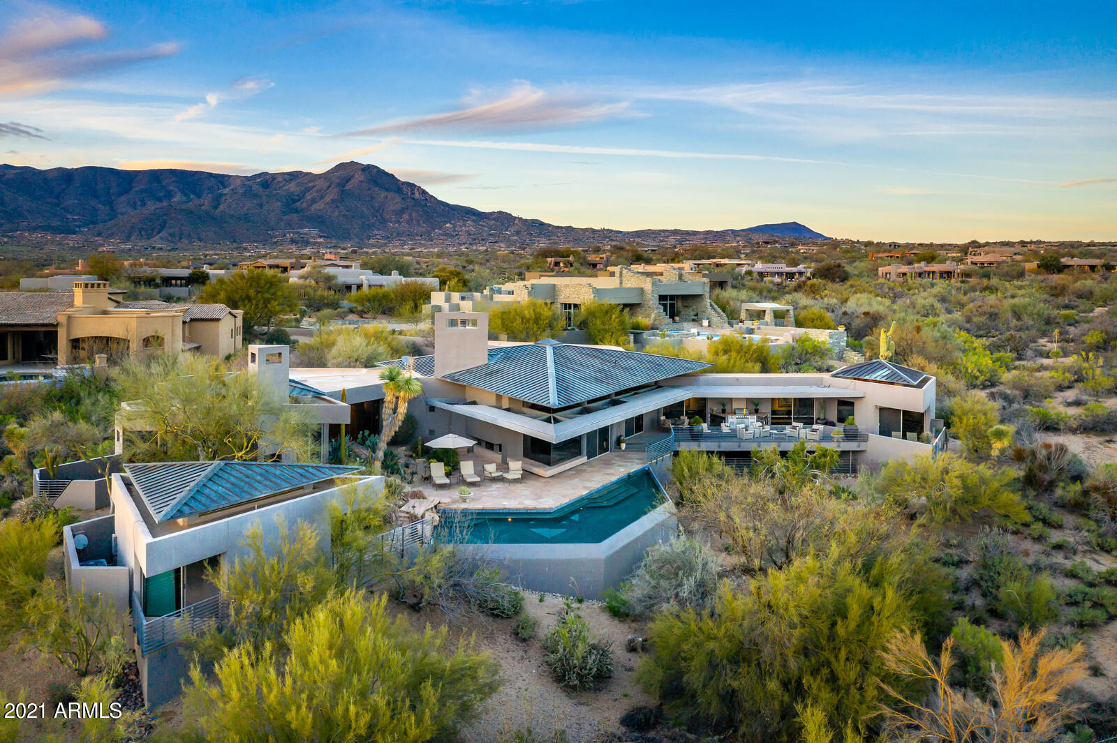 Truly one of a kind contemporary home on a fantastic lot.    Designed by renowned architect Gordon Rogers, this gem backs to over 30 acres of natural area open space with views to the McDowell Mountains, Pinnacle Peak, City lights and beautiful Arizona sunsets.  Offering three suites in the main home plus a detached casita, the floor plan is an open great room concept.  Architectural detail thruout the home from the steel beams, to the tongue and grooved ceilings to the many perfectly placed windows to allow an abundance of natural light.  If you are looking for a unique property that does not come along often, then take a serious look at this magnificent home.  List price includes all furniture, rugs, art, lamps, electronics and accessories.  Seller will provide an exclusion list.