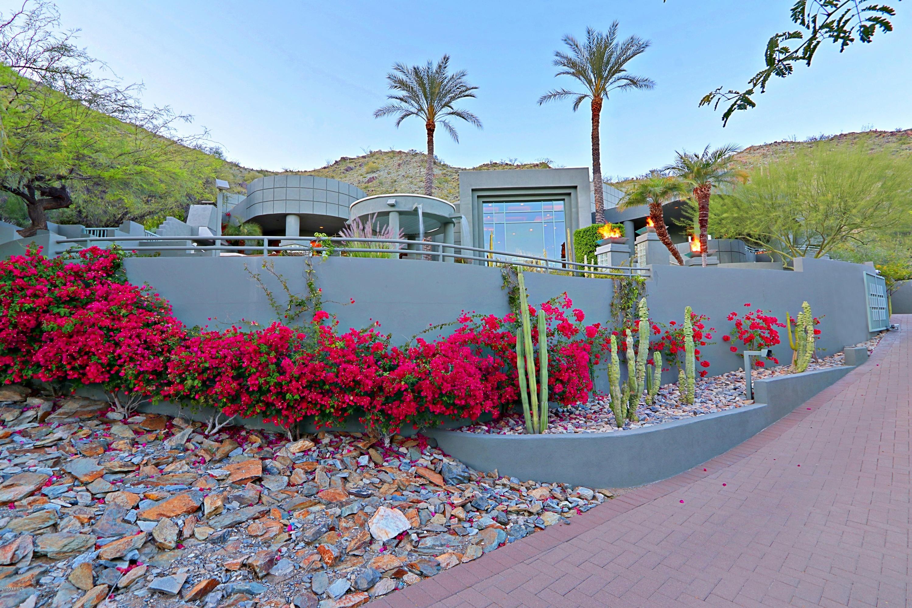 Nestled against the mountain preserve, this premium hillside home embodies Tatum Canyon luxury living!  Walls of glass and expansive wraparound patios combine with a perfect elevation to showcase the panoramic views of Camelback and surrounding mountains.  Situated up a privately-gated drive boasting six en-suite bedrooms and seven baths, its features include a sleek kitchen, office, theater, wine room, fitness center with a spa bath, resort-style pool and multiple outdoor entertainment areas.  For privacy reasons, photos are limited.  Additional photos available by request.