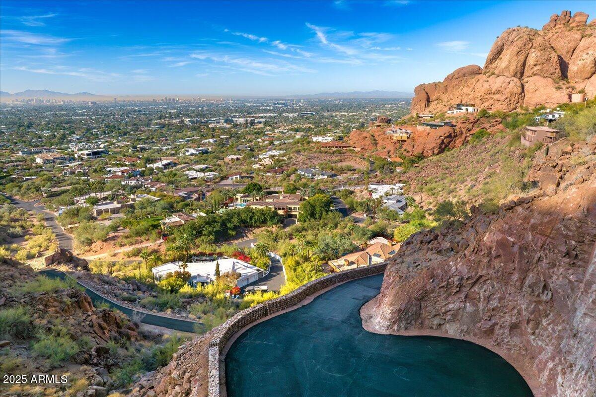 Offering the BEST VIEWS in Phoenix, this special property is situated near the top of Camelback Mountain and is unseen from the main road via a private gated drive that wraps around the property's red rock formations ending at an intimate building pad. It is bordered by land owned by the City of Phoenix, enhancing the privacy and seclusion of this unique property. Enjoy sweeping unobstructed 180-degree views of the city below. Build the dream home you have always wanted or utilize a set of custom plans which convey. Enjoy the stunning evening sunsets Arizona is known for as you overlook the Valley's cityscape and all of the stunning natural desert beauty which surrounds you. This is a once in a lifetime opportunity to own one of Camelback Mountain's premier homesites.