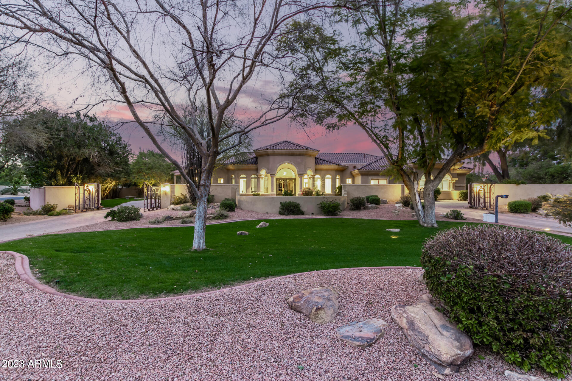 Stunning privately gated Estate on 1.3 Acres of lush landscaping. This remodeled home features 5 bedrooms all en-suite, 2 powder rooms, chef's kitchen / great room concept. Wrought-Iron front doors lead you to a formal entry w/ endless light viewing straight through to a resort-style yard w/ extensive covered & misted patio, resurfaced lap pool & spa, surrounded by a wall of mature trees & landscaping. The primary bedroom has a large spa-like bathroom, his/her walk-in closets w/ built-ins, access to backyard fireplace. The home also has a separate media/game room and a 4-car garage. Other features include new concrete roof, new R44 insulation, 3 new HVAC's, & too many other features to include. Walking distance to the shops & restaurants at Gainey Village, don't miss this pristine home!