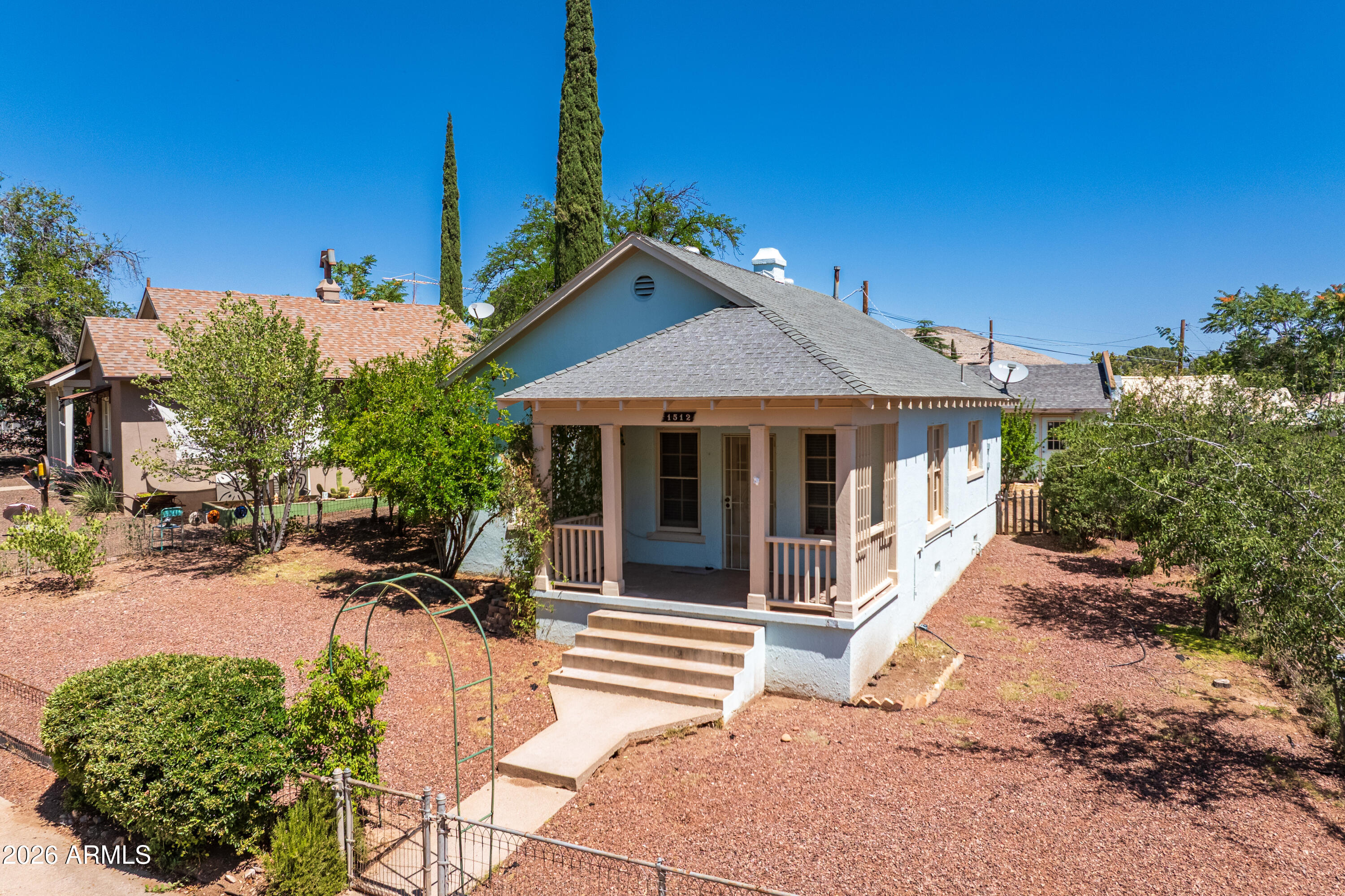 As you step into this charming historical  bungalow, it's a walk back in time. The covered front porch is a peaceful settling where neighbors sit and chat, the home has original hardwood floors, Jack and Jill bathroom with a jetted soaking tub/shower, laundry room with lots of storage and a stack washer/dryer. There is a 2 car garage with a 1 car garage door  with ally access and washer and dryer hookup, also a gardening storage shed in the back yard, along with many mature trees. What a wonderful community, with a nice park in the center of town where they have live entertainment and many community functions. Also this home is just a short drive away from Old Town Cottonwood.