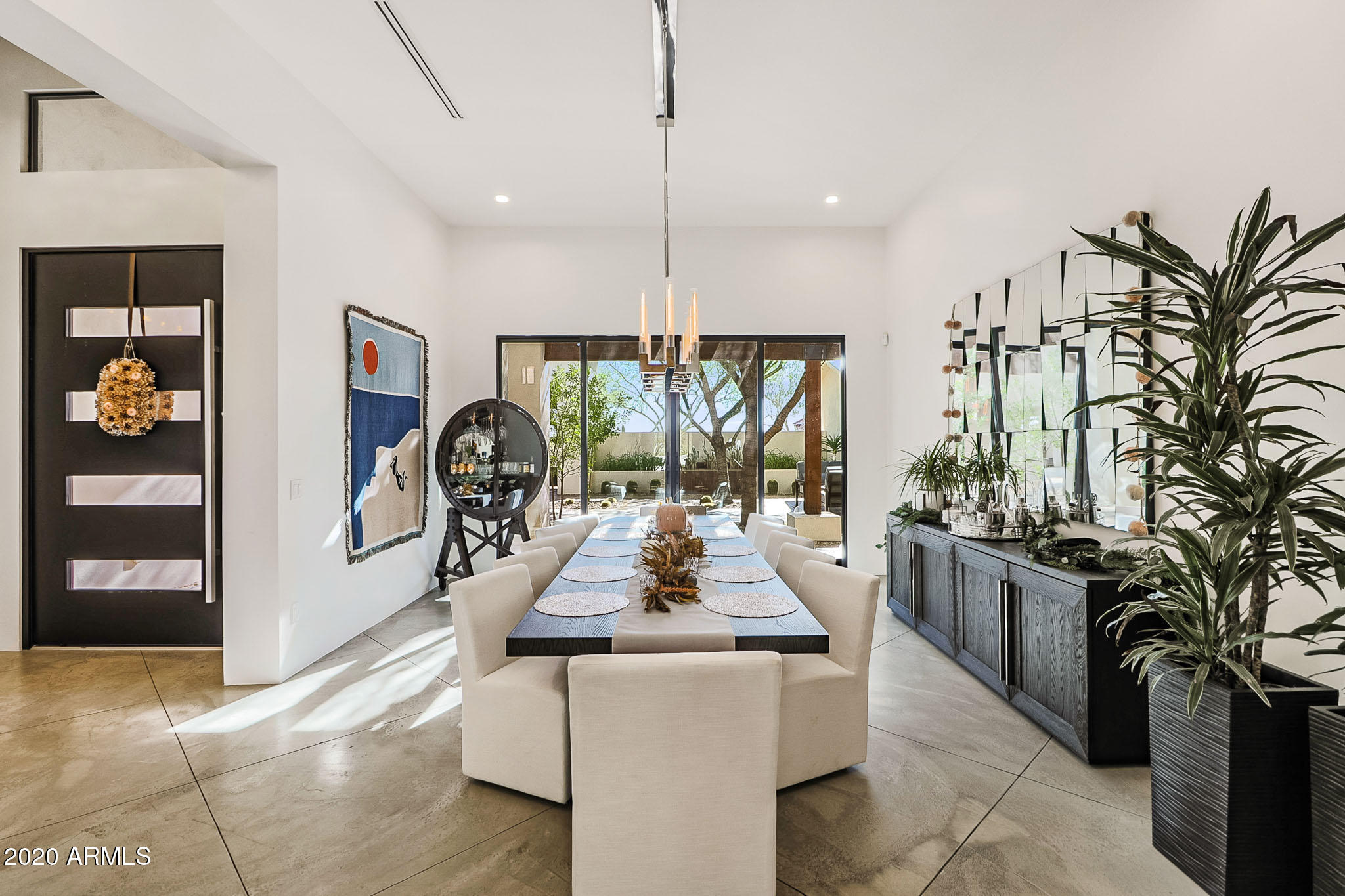Gorgeous 8200 sq ft Desert Contemporary dream home on 4.55 acres tucked back at the base of the mountain.  Secure front entry into courtyard.   Home controlled by the best smart home technology, Crestron. Family Room features 22' wood planked ceiling, stacked stone wall, gas fireplace sliding glass doors .  Chefs Kitchen features Dual Sub Zero plus additional Refrigerator/Freezer in Pantry, Gas Range w/pot filler, 3 ovens, warming drawer, ice maker, and warming drawer.   Downstairs Master Bedroom has his and her closets, steam shower, private courtyard, coffee station.    Separate Casita w/full kitchen (elevator can be installed)  Endless garage space, for your collector cars and/or all of your toys.   Backyard Dream:  Pool, Jacuzzi with fire bars, Large ramada with BBQ/oven/refrigerator, gas fireplace, 1/2 bath, outdoor shower,  misting system throughout pool area and Ramada, lighted tennis court/pickle ball/basketball court, batting cage and wiffle ball field.   This custom home builder did not miss a detail.