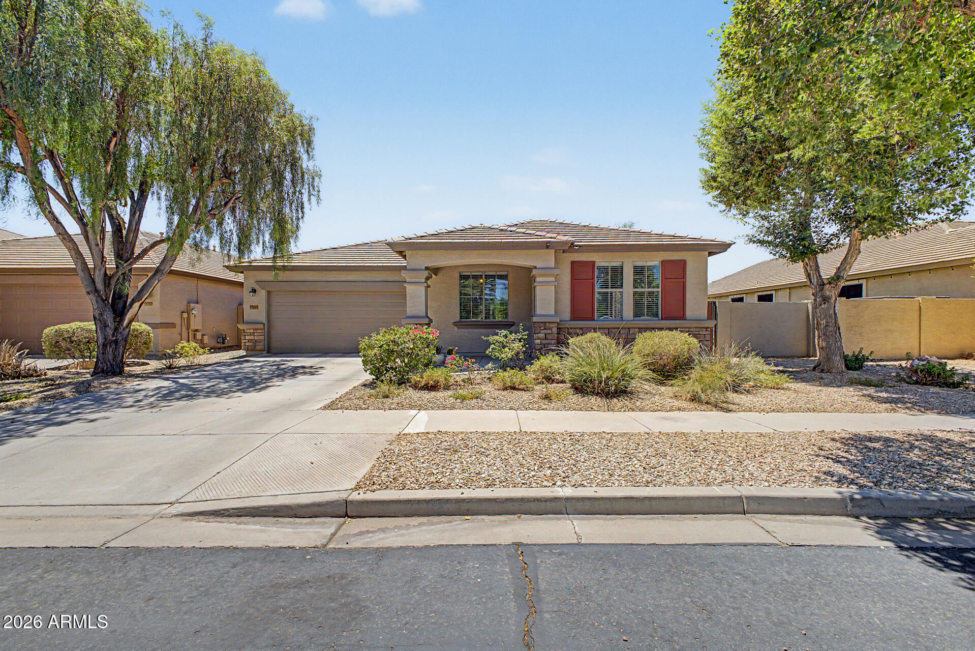 Welcome to this beautifully maintained single-level home in the gated community of Copper Canyon Ranch. Offering 2,291 sq ft of thoughtfully designed living space, this 3-bedroom, 2.5-bath home also features a dedicated den, making it ideal for those who work from home, need a hobby room, or simply desire additional flexible living space.  From the moment you arrive, you'll appreciate the pride of ownership and numerous updates throughout. Inside, soaring 9-foot ceilings and a combination of tile and wood-look luxury vinyl plank flooring create a warm, inviting atmosphere with no carpet to maintain. The spacious floor plan offers both formal and casual living areas, providing flexibility for everyday living and entertaining alike. The heart of the home is the open-concept kitchen family... room where family and friends naturally gather. The well-designed split-bedroom layout provides privacy for the primary suite, which features a spacious ensuite bath with dual sinks, a relaxing soaking tub, separate shower, and generous walk-in closet. Step outside and discover your own backyard retreat. The sparkling swimming pool and in-ground spa provide the perfect setting for relaxing Arizona evenings. A charming gazebo creates additional outdoor living space for entertaining, dining, or simply enjoying the beautiful weather. Recent updates included new A/C units in 2021, exterior paint in 2020, and interior paint in 2023. Located within a gated community and close to parks, walking paths, shopping, dining, entertainment, and convenient access to Loop 303, this home offers the perfect balance of comfort, convenience, and lifestyle.  This home is an exceptional Copper Canyon Ranch opportunity.