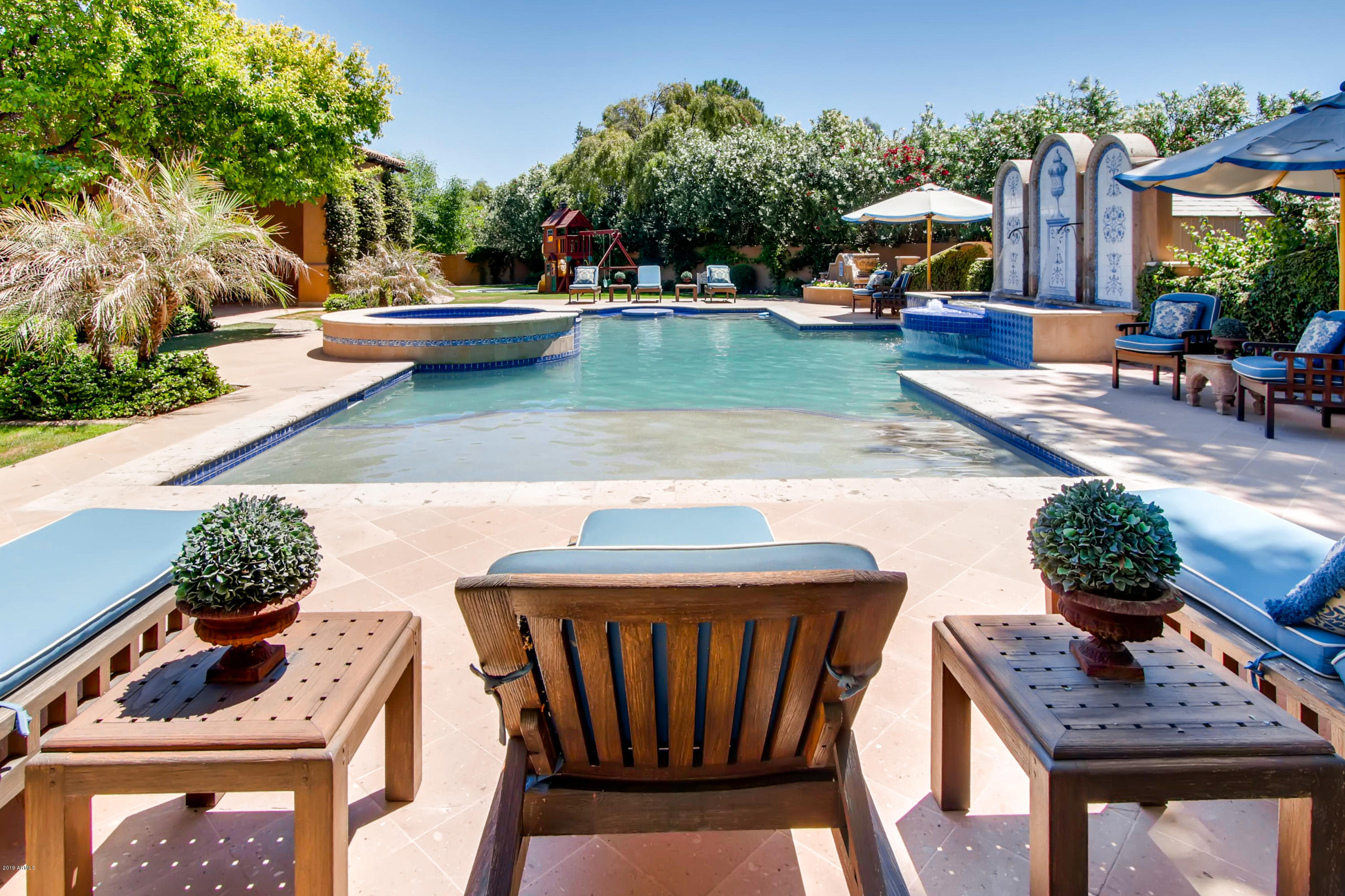 One of the most beautiful Gietz Master Builders custom estates ever designed, this home is perfect for entertaining and located in a private, serene neighborhood in Paradise Valley. Features include a secure double-gated entry, incredible custom tile details in every room, hand-carved limestone crown moldings, American Cherry hardwood floors, 4 custom fireplaces, 5 fountains, Shawn Stole custom millwork throughout, great room with retractable 10 ft high glass doors, 2 offices, wine room/walk-in cooler, 114 sq.ft pantry with rolling library ladder, game room, media room, French doors leading to quaint courtyards, stunning resort pool/spa with in-pool dining table and 2 fire features, numerous indoor-outdoor living spaces, lush landscaping throughout and temperature controlled 4-car garage.