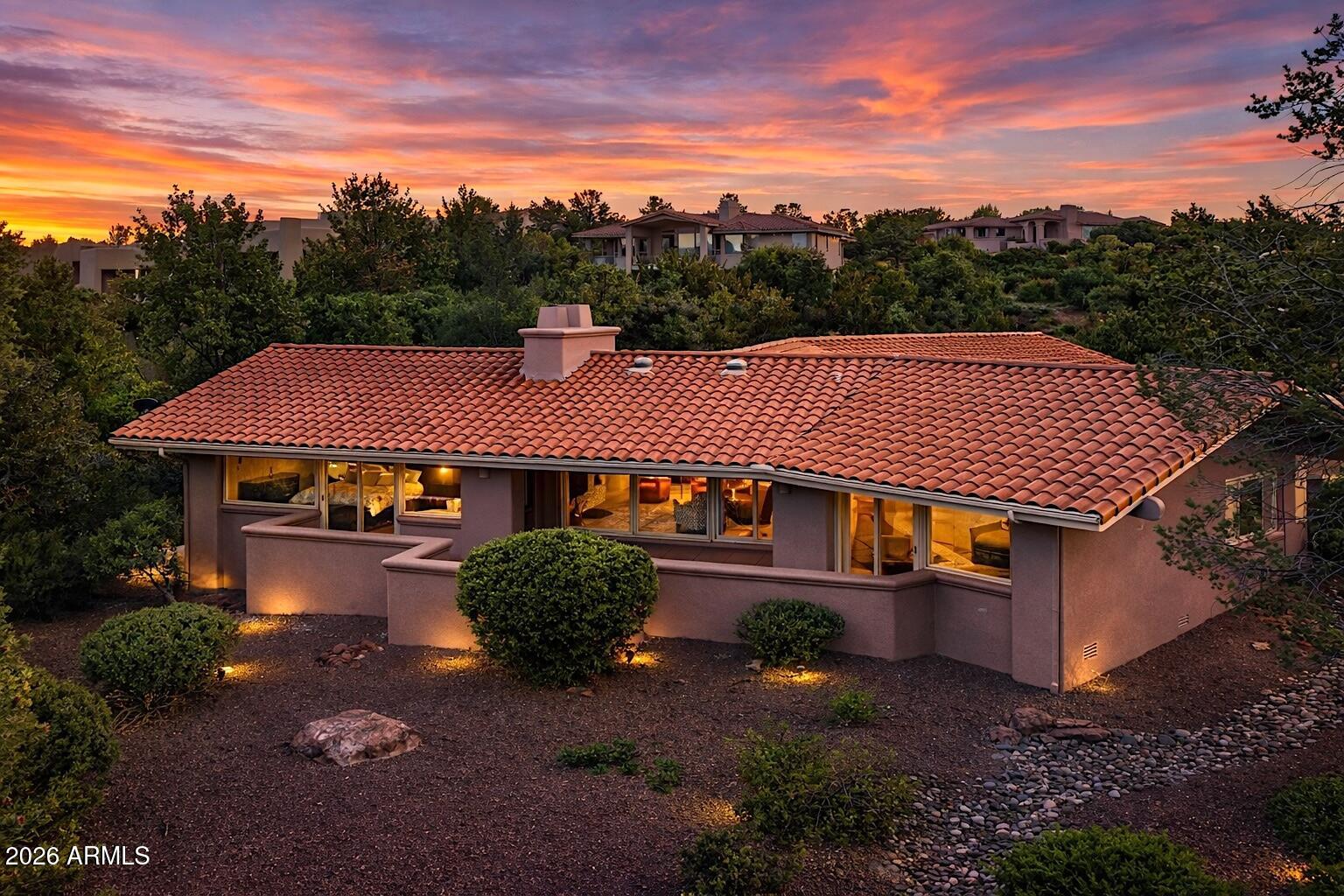 Located in one of West Sedona's premier gated communities, Foothills South, this one-story home was completely remodeled to reflect today's casual, understated lifestyle. The split floor plan features a wing for the primary suite with a separate sitting area and a walk-in closet with storage niches. A beautifully realigned primary bath includes dual sinks with undermount lighting, a slipper tub, a large walk-in shower & calming, subtle color palette.  The private patio offers evenings of enjoying our Sedona sunsets. Proceeding to the kitchen, there is an expansive island with seating, creating an entertainment area for easy flow & rich wood cabinets with inset lighting that enhance the ambiance.  In addition, there is a built-in wine rack, a gas stove, and a stunning glass tile backsplash with touches of light blue and taupe, plus more storage.  A half bath and laundry room are to the side of the kitchen, along with another exterior patio.  Entering the spacious great room, there is a fireplace with floor-to-ceiling stack stone, a dining area & another patio with west views.   The two large guest bedrooms are off the great room, complemented by a ¾ bathroom with framed modern tile pattern.  Finally, there is an oversized 2-car garage off the circular driveway, with built-in custom storage and room for a workbench.    This is a unique Sedona home, which can be either a great primary or secondary home. The location is central to the center of town with 4 grocery stores, movie theaters, shopping, hiking, and biking.
