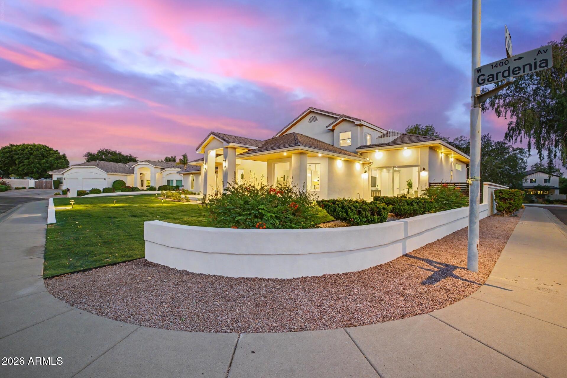 One of the largest and highest-quality renovations in all of North Central Phoenix -- grand in scale, exceptional in execution, and priced to deliver remarkable value. This fully reimagined turn-key residence offers 5 bedrooms, 6 bathrooms, a dedicated first-floor office, and an expansive upstairs loft -- a rare combination of space, flexibility, and craftsmanship you simply don't find at this price point. Soaring ceilings define the experience throughout. Dramatic volume in the main living area and kitchen creates an airy, light-filled great room, while 16-foot ceilings crown the primary bathroom and kids' bedroom. The upstairs loft serves as versatile bonus space ideal for homework, play, or hangouts. The chef's kitchen anchors the open main level with marble countertops and matching marble backsplash, premium Viking and Bosch appliances, and seamless flow into the living spaces. Marble continues throughout the bathrooms and pantry, paired with new blonde hardwood floors and a dramatic wrought iron banister. Every bedroom features its own enormous walk-in shower.
Indoor-outdoor living is the heart of this home. Two sets of massive sliding glass doors open the entire living area to a 600+ square foot covered patio with a striking beam awning -- built for year-round Arizona entertaining. Beautiful white limestone, lush landscaping, custom lighting, and full irrigation finish both the front and back to the same exacting standard as the interior. Additional upgrades include HVAC, epoxy garage flooring, and dual washer/dryer sets -- with a second set thoughtfully tucked into the primary closet for ultimate convenience.Just across the street, an expansive open field offers room for the kids to run and play, right next to a gated sport court for basketball, pickleball, and tennis.Move-in ready -- an extraordinary opportunity in one of Phoenix's most desirable enclaves.