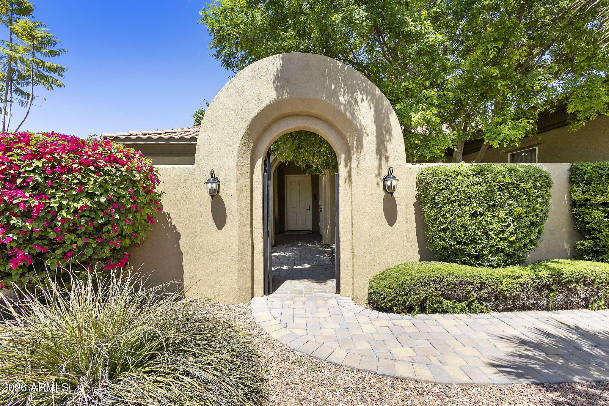 If you enjoy gardening, swimming, lounging, and true Arizona outdoor living, this popular updated Encanto in Corte Bella Country Club checks every box. Beautifully positioned within one of Sun City West's premier active adult communities, this home offers a resort-style backyard with a heated pool and spa, fenced yard, turf, covered patio, and built-in BBQ area designed for relaxing, entertaining, and enjoying the Arizona lifestyle. A welcoming gated courtyard with a 6' wall and arched entry creates a private oasis from the moment you arrive. Step through the courtyard gate and feel transported into a peaceful retreat, complete with access into the kitchen through French doors. The grand entry is enhanced by a new 8' front door, setting the tone for this charming home with 10' ceilings, thoughtful updates, and inviting indoor-outdoor flow from the front courtyard all the way to the backyard. Inside, the home offers a warm color palette, luxury vinyl plank flooring throughout the main living areas, carpeted bedrooms, and upscale window coverings. The updated kitchen features tasteful blue cabinetry, an 8' center island, pantry, stainless steel appliances, breakfast nook, and direct courtyard access--perfect for morning coffee, gardening enjoyment, or evening gatherings. The split floorplan provides privacy for guests and everyday comfort. The primary suite is conveniently located near the laundry room and garage entry, with an updated bath featuring a new shower, closet system, updated sinks and counters, and a high-end bidet with remote. The guest bedroom, guest bath with high-end bidet, hallway, and den are located on the opposite side of the home, creating excellent flex space for hobbies, office use, or visiting family. Additional features include a laundry room with utility sink and multiple storage cabinets, tankless water heater, split A/C system with remote, and an impressive extended garage with 10' ceilings and cabinetry on both sides. Enjoy the sought-after Corte Bella Country Club lifestyle with golf, fitness, dining, swimming, pickleball, social activities, and resort-style living right in the heart of Sun City West.