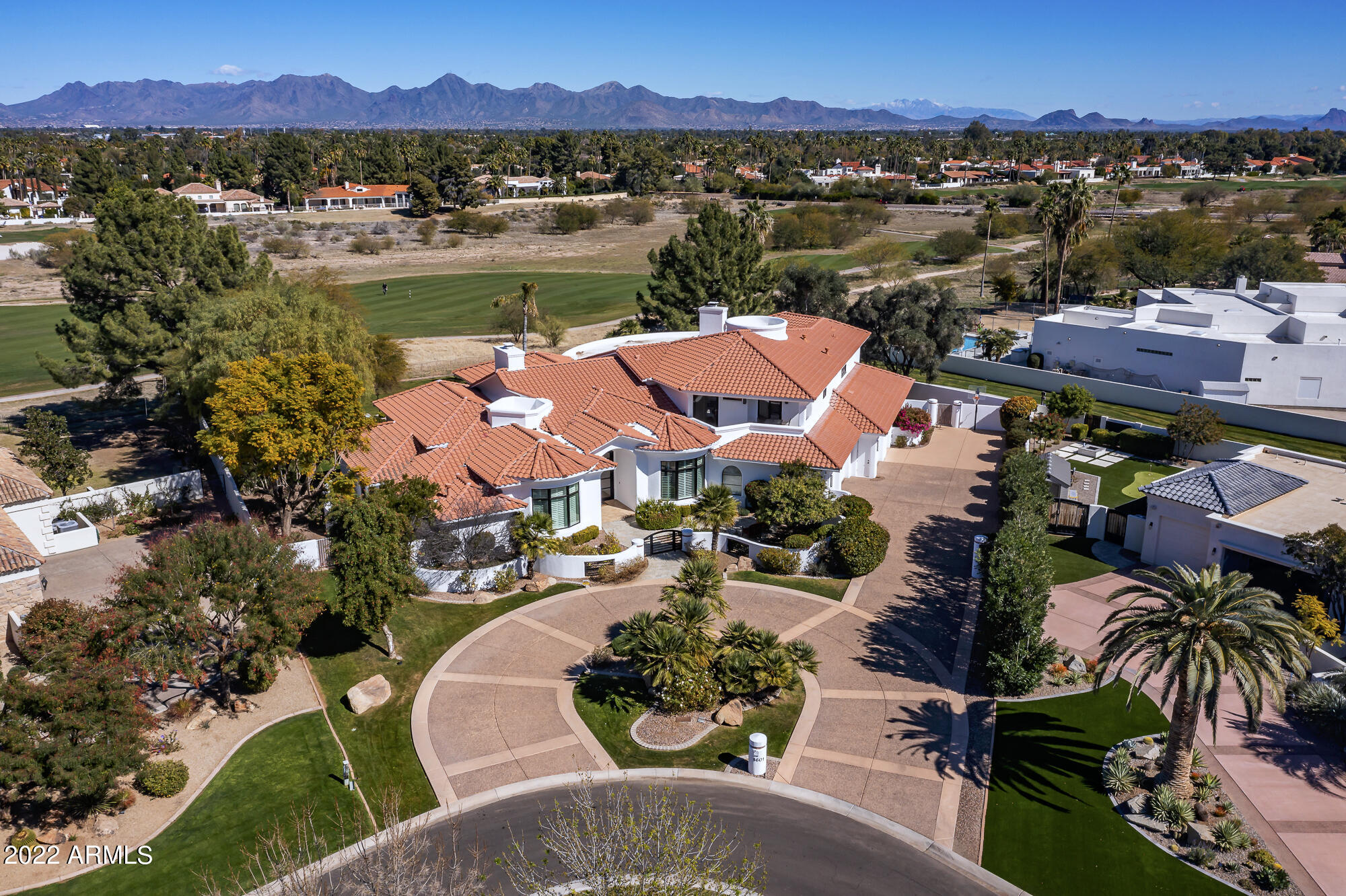 Located in the heart of Paradise Valley, this beautifully crafted custom estate is set amongst the prestigious Camelback Golf Course and situated in the highly regarded, gated Merrill Cantatierra community. The manicured cul-de-sac grounds offer exclusive mountain views, fully equipped guest quarters with separate entry, every hosts idyllic backyard retreat with an expansive covered patio, direct patio bathroom, mature greenery, a heated pool, spa, barbecue and wood burning fireplace. The desirable split floor plan provides a secluded ground floor master wing with custom his + her's built-in closets, an adjacent executive office, a home gym, meticulously maintained kitchen and grand spiral staircase leading to the three top floor guest suites, each complete with a private view balcony. Enhanced by soaring 25 ft tongue and groove wood ceilings, custom millwork, abundant indirect natural light, floor to ceiling windows, and phenomenal attention to detail, this home presents a seamless indoor + outdoor luxury living experience. See MOTION VIDEO