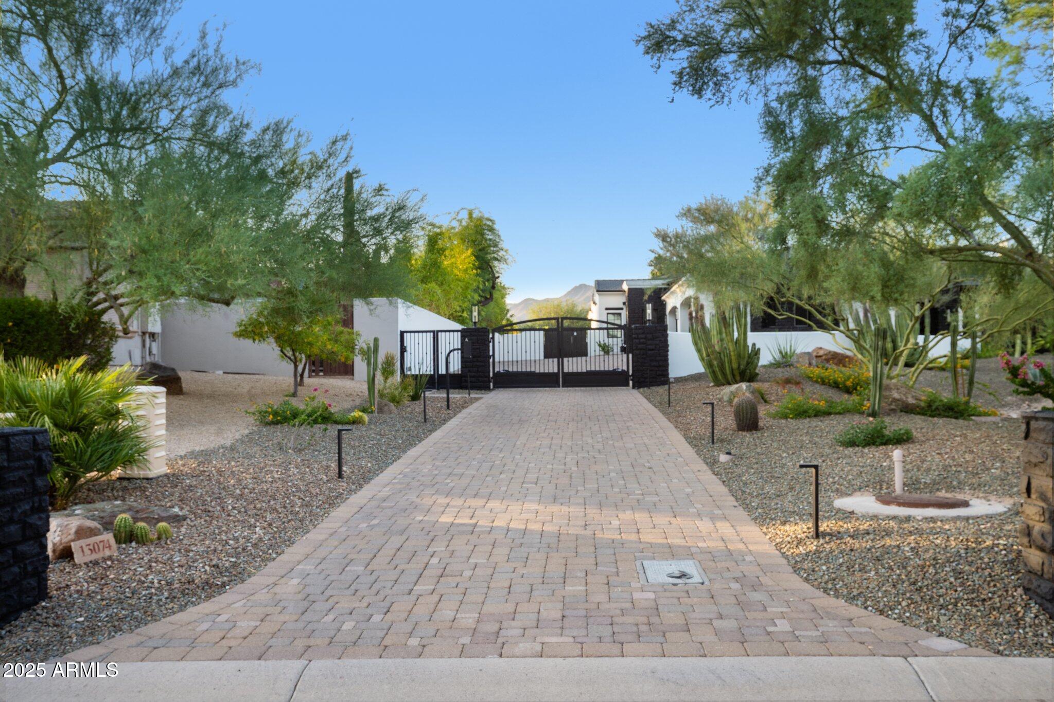 Behind a private gated entry driveway on quiet cul-de-sac this no-HOA spectacular estate has been fully transformed, offering opportunity to own a designer-finished home inside and out that lives like new. This property features more than $1.1 million in recent upgrades, including private travertine outdoor living with water/fire feature, 6 outdoor sound systems, 12-foot backyard walls sculpted to maximize privacy & mountain views, pool/spa, turf & hardscape, huge covered patio, multiple TVs, surround sound, fireplaces, and outdoor kitchen. A designer home w/ full chef's kitchen, soaring architectural ceilings, rotundas, curated finishes, sanctuary primary suite w/ 2 sitting areas, dual-sided fireplace, 2 generous walk-in closets, dual water closets, and a spa-caliber bath w/ sauna & gym. This property truly is architectural brilliance meeting turnkey luxury in a Scottsdale Mountain view estate. This spectacular estate has been fully transformed, offering the rare opportunity to own a fully designer-finished home and outdoor living spaces. Set against a breathtaking 360° backdrop of rugged mountain peaks and brilliant desert skies, this is where timeless design meets effortless resort living. This property features a newly refinished travertine courtyard with its own full-size gated entry, a fireplace, a unique water/fire feature and a full outdoor sound system. The courtyard leads to a dramatic arched entry, where a custom over-sized iron door opens into interiors defined by soaring beamed and barrel ceilings, two rotundas, rich textures, and curated finishes. A Restoration Hardware-featured fireplace anchors the formal living room, setting the tone for spaces that are as architectural as they are welcoming. At the heart of the home, a custom chef's kitchen stuns with dual marble-topped islands, glazed cabinetry, a mother-of-pearl backsplash, and top-of-the-line Wolf, and Sub-Zero appliances, w/ a separate bar and wine room in the family room. Whether hosting a crowd or cooking solo, every detail is designed to elevate the everyday. The primary suite is a sanctuary of scale and serenity. Enjoy a private sitting area, dual-sided fireplace, two generous walk-in closets, dual water closets, and a spa-caliber bath complete with sauna and fitness room. Each guest suite offers its own luxe ensuite bath and walk-in closet, while the detached casitaw/ kitchenette, full bath, and walk-in closetwelcomes guests or extended family with style and privacy. Modern luxury is woven into every corner: an upgraded Savant smart home system integrates lighting, sound, HVAC and AV throughout. Ten ultra-thin Sony 4K TVs, Sonos soundbars, architectural speakers throughout the entire house and exterior, and a newly upgraded 8K projector in the custom home theater deliver an immersive entertainment experience. A commercial-grade Cox Gigabit hardwired WI-FI internet system ensures seamless connectivity. The resort-caliber backyard feels like a private retreat, complete w/ a newly resurfaced Pebble Tec pool and spa, brand-new turf and hardscape, a dramatic outdoor fireplace, and a newly outfitted kitchen with built-in grillall set beneath a covered travertine patio with new ceiling fans and a surround sound TV system. Major enhancements include a complete reimagination of the entire outdoor area of this 1-acre estate, enlarged car parking area, new gated driveway with connected walls for privacy and security, all-new exterior and interior paint, a new concrete tile roof with a 15-year warranty and all new flat roof w/ 12-year warranty, and five new HVAC systems, EV charging outlet in the garage, updated Savant system, new speakers and sound bars throughout, new theater AV equipment, newly imagined family room built-ins and fireplace, with updated lighting, cabinetry and countertops throughout. From sweeping views to sophisticated details, every inch of this property has been elevated. This is more than a homeit's a design-forward lifestyle and a rare opportunity to own one of the most refined and turnkey estates in the desert.