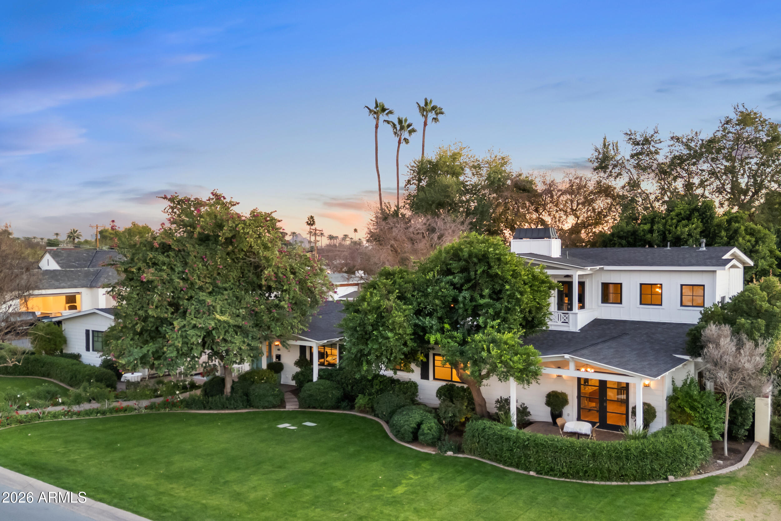 Set on a rare 16,575-square-foot corner lot in one of Arcadia's most desirable and walkable neighborhoods, located within the Arcadia school district serving Hopi Elementary, Ingleside Middle School, and Arcadia High School, this beautifully remodeled residence delivers an exceptional blend of charm, livability, and outdoor lifestyle. A floral-lined pathway with mature trees and elegant plantings creates a striking and welcoming first impression, setting the tone for the warmth and privacy found throughout the property. Thoughtfully remodeled and expanded in 2015, the home spans 3,899 square feet and offers 4 bedrooms, 4.5 bathrooms, a private office, and a large playroom or teen space, providing flexibility for family life, guests, or multigenerational living. 

Multiple living areas are designed for the way people truly live and entertain, anchored by a kitchen featuring custom cabinetry, natural stone countertops, professional-grade appliances, gas cooking, a coffee bar, and seamless flow into light-filled living spaces that open to the backyard through large sliding doors.

The primary suite is a true retreat, perched among the treetops with views of Camelback Mountain and Piestewa Peak. Vaulted, beam-accented ceilings, a fireplace, and access to a private balcony create an elevated sense of escape. Enjoy morning coffee or colorful sunsets from the balcony, or unwind in the spa-inspired primary bath featuring dual vanities, a soaking tub overlooking mature trees, a walk-in shower, beverage center, and stackable washer and dryer for added convenience.

Designed for Arizona living at its best, the backyard is ideal for entertaining and everyday enjoyment. Mature landscaping surrounds a resort-style pool, outdoor shower, built-in BBQ, gas firepit, bistro lighting, and multiple dining and seating areas for festive gatherings or quiet evenings at home. A dedicated garden area with planter boxes offers space for those who enjoy gardening beyond entertaining.

Tucked away on the property is a detached, powered and air-conditioned structure, ideal as a wellness space, art studio, or private retreat. There is also an opportunity to add a detached casita without sacrificing valuable backyard space.

Additional highlights include a three-car garage with storage, wood flooring throughout, water softener and kitchen filtration system, pre wiring for outdoor audio, security system with cameras, and beautifully maintained landscaping.

All of this is within walking distance to LGO, Ingo's, and North, near top private schools including Christ Lutheran School (CLS) and Phoenix Country Day School (PCDS), and just minutes from the Biltmore, Scottsdale Fashion Square, Sky Harbor Airport, Camelback Mountain, and the Global Ambassador Hotel. A truly special opportunity to enjoy space, privacy, mountain views, and unmatched neighborhood charm in Arcadia Lite.