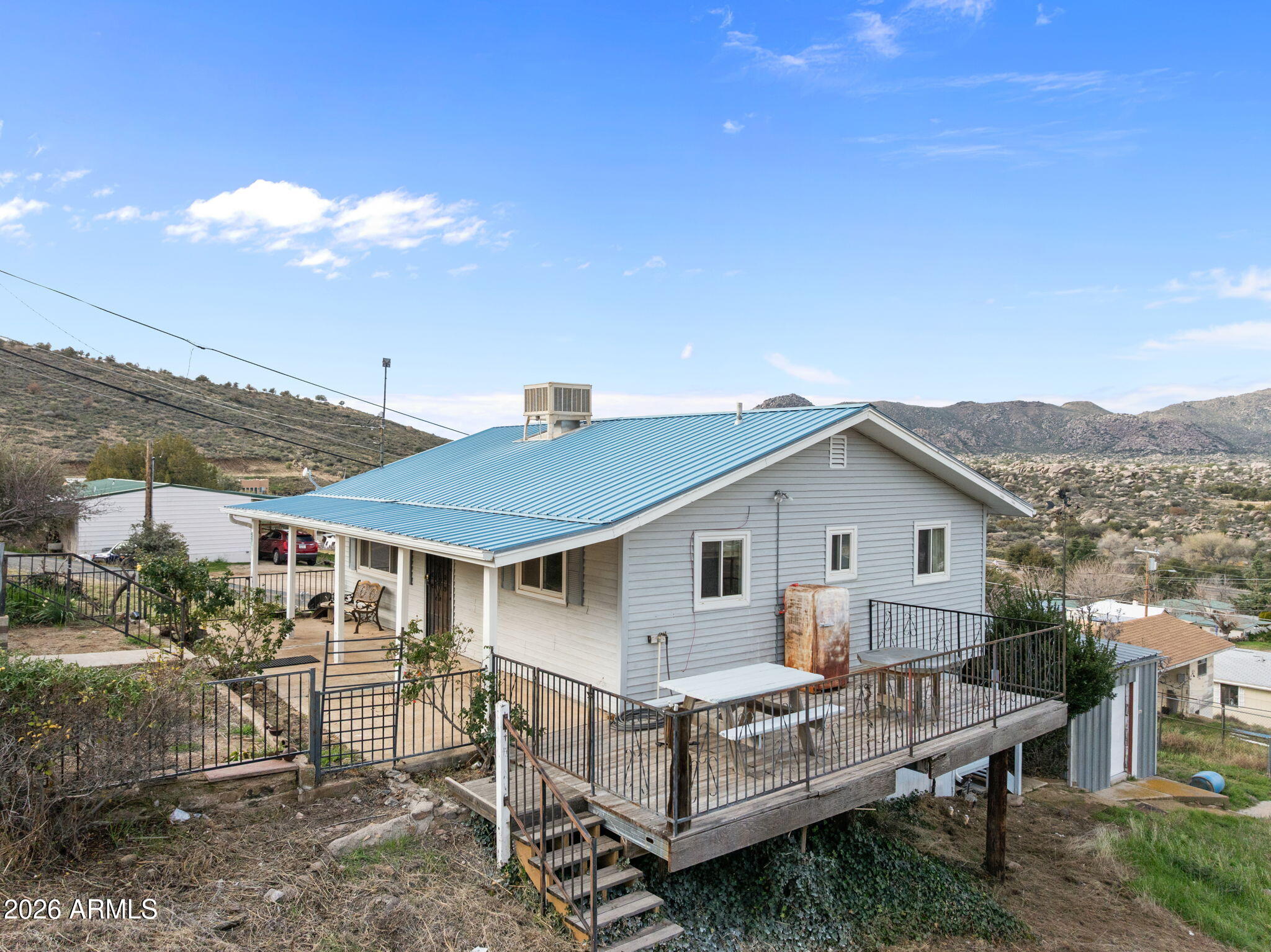 Charming hillside property in Yarnell offering peaceful rural living and scenic mountain views.  Where the mountain air meets the desert breeze. The main parcel features a stick-built, single-story ranch-style home of approximately 1003 sq ft, along with a detached garage. The sale includes two parcels conveyed together, totaling approximately 0.6 acres, providing added space and flexibility. Situated on the edge of a picturesque hillside, this property offers a quiet setting with beautiful surroundings and potential for a variety of residential uses under Yavapai County R2-3 zoning (buyer to verify). Ideal for those seeking a serene retreat, full-time residence, or investment opportunity in a unique Arizona mountain community. Buyer to verify all facts, zoning, and intended uses
