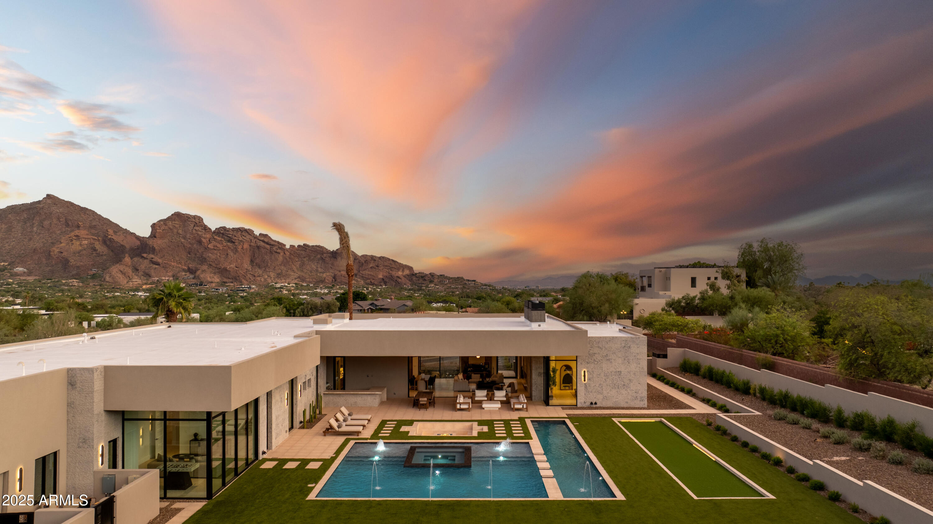 Experience unmatched elegance in this spectacular brand new estate from Patterson Homes, showcasing 7,432 square feet of contemporary luxury on a pristine, flat acre lot with hillside views. The residence features five spacious bedrooms, each thoughtfully oriented to capture the mountain vistas—including extraordinary sightlines of iconic Praying Monk from the main living space. Additional highlights include an elegantly appointed office with fabulous mountain views, a state-of-the-art home theater, a luxurious half bath, and an airy kitchen complete with a large back kitchen, perfect for hosting gatherings of any size.

Stay active in the home gym, offering inspiring views of your private backyard oasis, then step outside to a beautifully landscaped yard complete with a stunning sun deck, elevated spa, large play pool, dedicated full-length lap pool, and a professionally designed bocce courtall set against the majestic backdrop of Mummy Mountain. Benefit from the convenience of a spacious four-car garage, with every element meticulously curated to embody sophisticated luxury and modern living. Further details are available upon request.