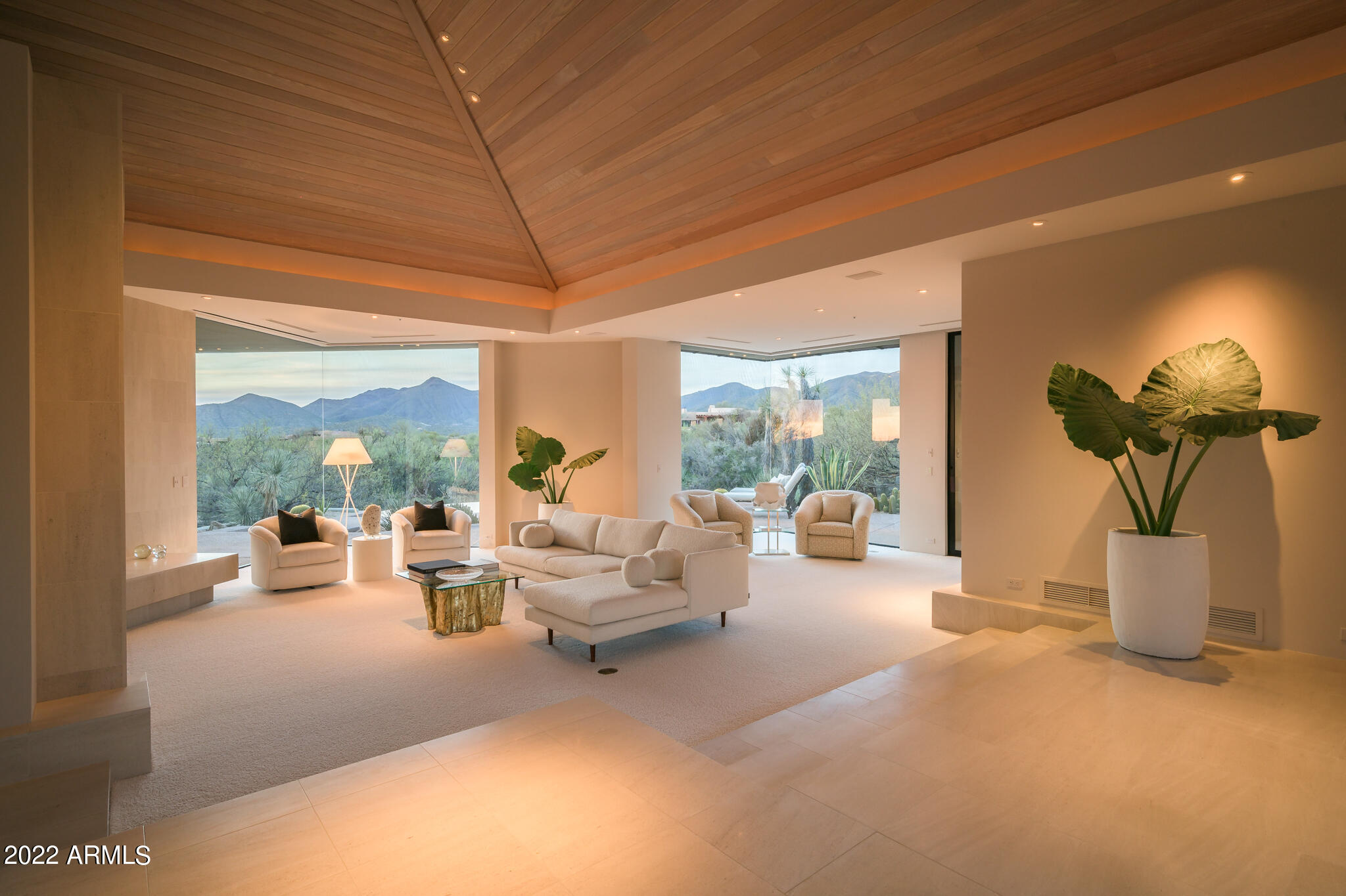 This rare contemporary property, located in the highly sought after community of Desert Mountain, features clean-lines in the copper roofing, wood ceilings, glass walls and limestone floors with 3 bedrooms, including the casita, 4 bathrooms and an executive office overlooking the pool. Constructed by award winning builder, Phil Smith, and tucked at the end of a long driveway sits this sprawling and thoughtfully-designed retreat which won the Golden Nugget Award of Merit. This home is known for its natural light and open floor plan of 4,840 sq ft. From the well equipped kitchen with gas cooktop stove and a large island to the fireplaces in the kitchen, living room/office/patio and master bedroom, this home offers great perfection in the details. great perfection in the details. The circular driveway leads into the 3 car garage with built-in cabinets and extra storage closets. This property also features lush landscaping with expansive mountain, city light and sunset views and the backyard is on par with a private resort, showcasing a negative edge pool, spa, built-in BBQ and multiple sunning areas. The estate includes lot 37 upon which the home is located as well as adjoining lot 36 to the South which provides a privacy barrier (APN: 219-56-037 and 219-56-036). A Desert Mountain Club Membership is available to be transferred with this property. A 30-day membership application review and approval is required. Contact the Desert Mountain Club for details.