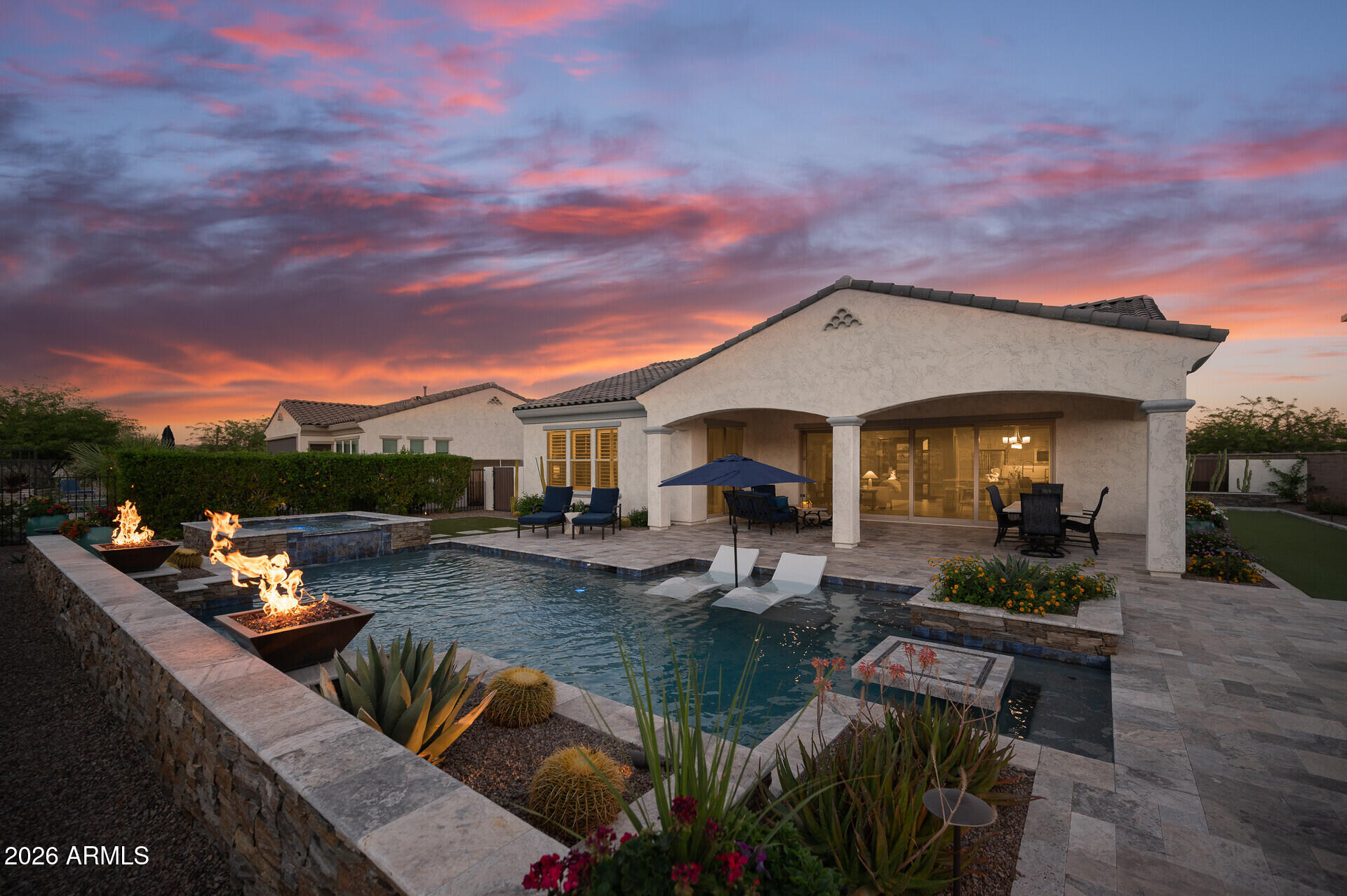 Single story pool home with a golf course lot on the 11th hole of the Victory course with panoramic views of the white tank mountains on an oversized lot in the active adult community, Victory. The moment you open the front door you are welcomed by a 19 foot slider opened to a backyard oasis with heated pool, spa, fire features, fire pit, outdoor BBQ & bocce ball court. Custom white shaker kitchen with large island, stainless steel appliances & walk in pantry.  Wood beams cover the ceiling of the kitchen & living room area.  Master bedroom overlooks golf course with mountain views Master bath with dual vanity sinks, walk in shower, custom shelving in master closet & access to the laundry. Home has an additional 2 bedrooms, bath plus office with doors. Community has golf, spa, gym & more