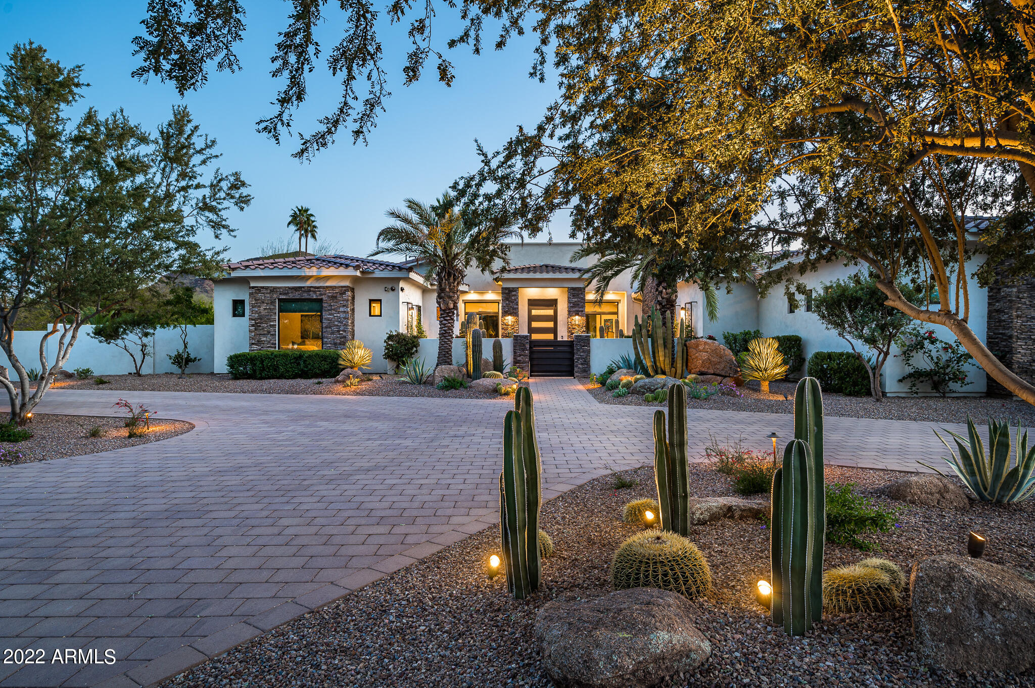 LOVE WHERE YOU LIVE in this Paradise Valley masterpiece with 6866 sq/ft of modern opulence and the ideal N/S exposure!  As you walk through the private courtyard adorned by a roaring fireplace, you enter an entertainer's paradise, with a grand open great room blending seamlessly out to a massive covered patio, providing the indoor/outdoor living that Arizona is famous for!  With a spacious master split from the other 4 bedrooms (all en-suite), the home provides all the comfort and space that any family or guests would need.  The completely renovated Chef's kitchen leaves nothing to desire as the designer left no stone unturned and makes this truly the heart of the home!  A 4 car garage, firepits, outdoor kitchen, and a completely redesigned landscape package round out this amazing home!!