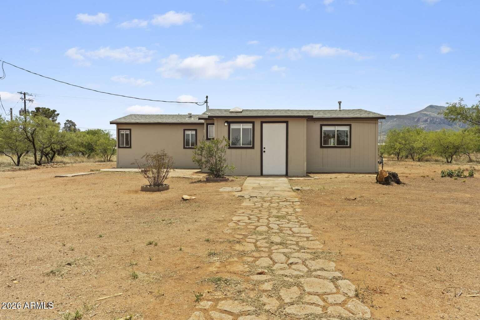 Charming and updated home situated on over an acre in Sierra Vista! This 2bedroom, 1bath residence offers 990 sq ft of thoughtfully refreshed living space with new flooring and baseboards throughout, fresh interior and exterior paint, and modern finishes. The kitchen and bathroom feature new quartz countertops, updated sinks, faucets, and stylish light fixtures, along with a new bathroom vanity. Stainless steel appliances add a sleek touch to the kitchen. Enjoy outdoor living under the covered patio with plenty of space to expand, store, or create your ideal outdoor setup. A great opportunity for those seeking space, updates, and privacy!