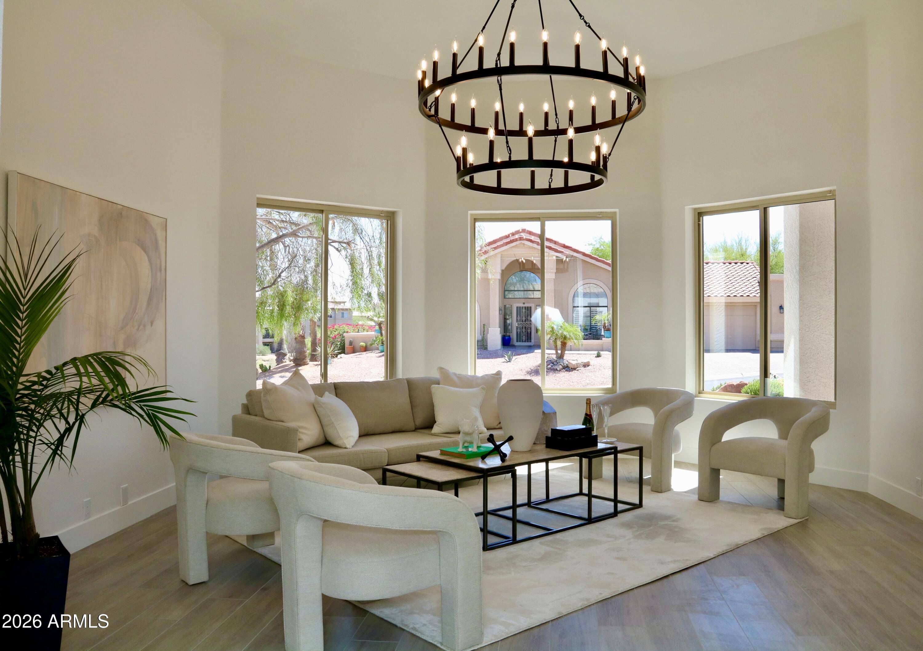 Beautifully redesigned and fully upgraded, this stunning residence showcases the work of a professional interior designer and is set against breathtaking mountain views. Recent improvements include a new roof, windows, patio doors, interior doors, flooring, custom cabinetry, and more--offering peace of mind and true move-in-ready convenience. This spacious 3-bedroom + den, 3-bath home seamlessly blends timeless comfort with modern elegance. The thoughtfully updated interior features high-end finishes, beautifully remodeled bathrooms, and a striking powder room with premium fixtures. Step outside to a tranquil backyard retreat, complete with newly installed turf, a covered patio, and low-maintenance desert landscaping--perfectly positioned to enjoy Arizona's spectacular sunsets. A rare opportunity to own a fully upgraded home with exceptional design and lasting value--this one won't last.