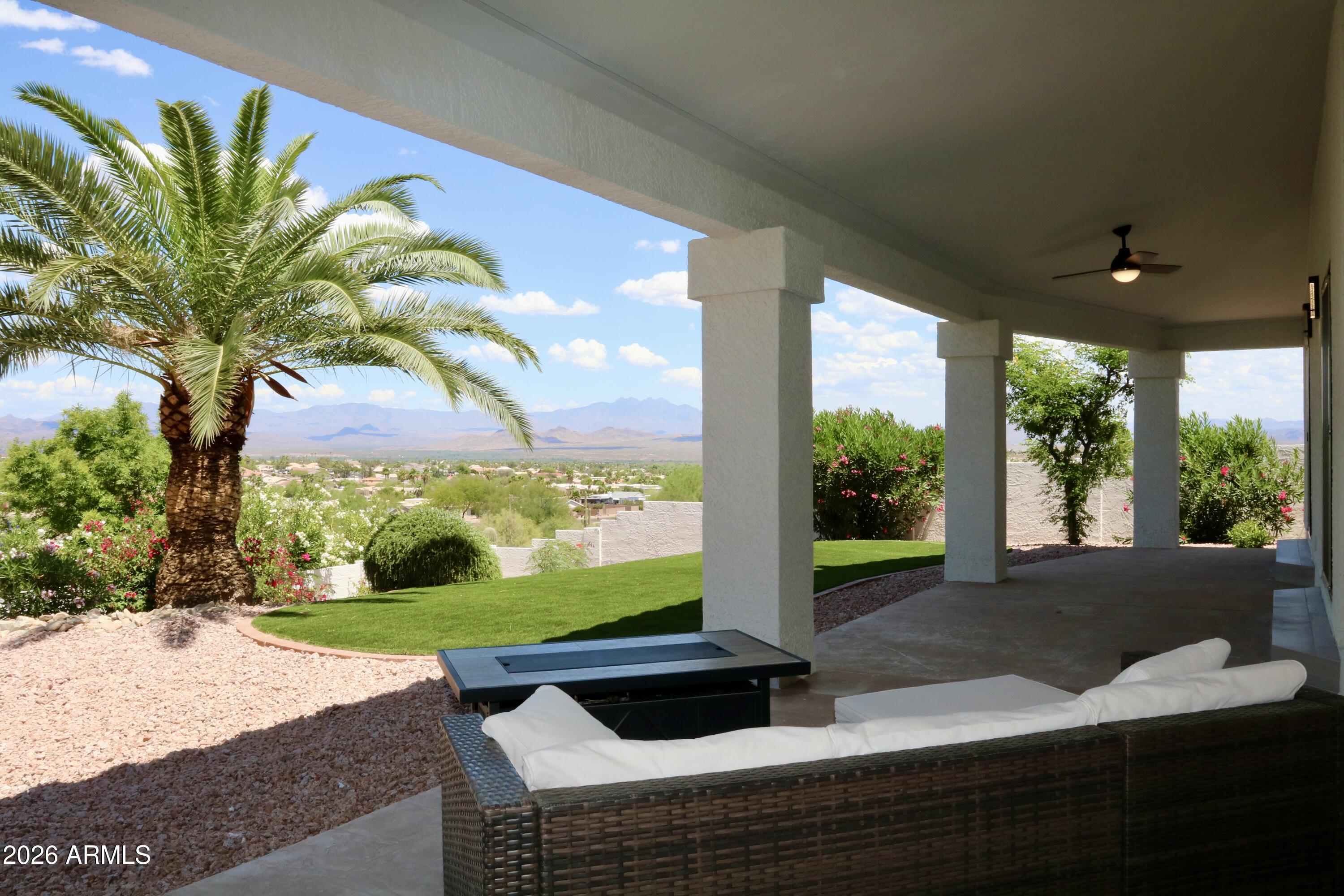 Beautifully redesigned and fully upgraded, this stunning residence showcases the work of a professional interior designer and is set against breathtaking mountain views. Recent improvements include a new roof, front door, patio doors, interior doors, flooring, custom cabinetry, and more-offering peace of mind and true move-in-ready convenience. This spacious 3-bedroom + den, 2.5-bath home seamlessly blends timeless comfort with modern elegance. The thoughtfully updated interior features high-end finishes, beautifully remodeled bathrooms, and a striking powder room with premium fixtures. Step outside to a tranquil backyard retreat, complete with newly installed turf, a covered patio, and low-maintenance desert landscaping--perfectly positioned to enjoy Arizona's spectacular sunsets. A rare opportunity to own a fully upgraded home with exceptional design and lasting value--this one won't last.