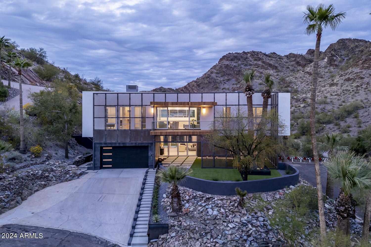 Biltmore Highlands, located on a hillside bordering the Phoenix Mountain Preserve Piestewa Peak. This residence combines nature's tranquility with urban convenience, offering breathtaking & unobstructed mountain, and city views! Minimalist-style kitchen with ample storage, and a complete butler pantry. The primary bedroom has a sizable walk-in closet w/built-ins and a lavish ensuite with dual sinks & soaking tub. The upstairs laundry room is complete with sink & cabinetry. Discover the entertainer's backyard, where an elevated negative edge pool awaits for refreshing swims, or chill and take in the mountain views. The rooftop party deck is an excellent spot to savor those amazing sunsets complete with an outdoor kitchen. You have a private gate to access the Phoenix Mountain Preserve! The scrim that covers the front and east side of the home creates a solar passage, increasing efficiency, privacy, and once it rust it will allow the home to blend with its desert surroundings. A huge covered patio in front of the home allows you to enjoy indoor-outdoor living when opening your matching 4-panel pocket doors and 8 pivot doors, doubling your space for entertaining. World-class hiking right out your back gate! Just Minutes from Old Town Scottsdale, Sky Harbor Airport, and downtown Phoenix. Located near the 51 freeway, without the noise, that gets you to the 10 or the 101 freeways in minutes.