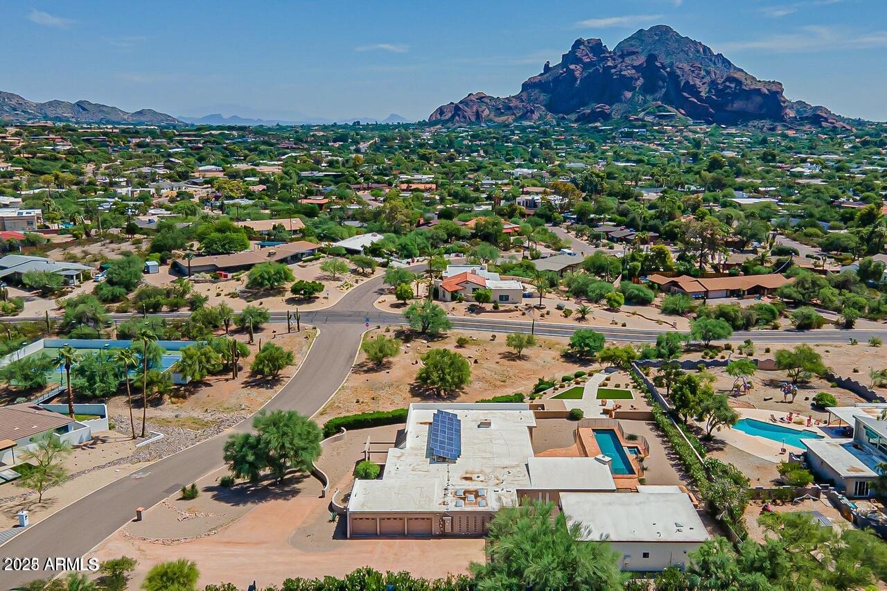 Set against the striking backdrop of Camelback and the Praying Monk, this premier 1.2+ acre Paradise Valley property delivers unmatched views and endless potential. The former residence has been cleared, leaving a sleek 884± sq ft guest home and an oversized 3-car garage—perfect for living on site during a custom build. The guest house includes a full kitchen, laundry, separate parking, and a versatile one-bedroom design that easily converts to two bedrooms. Resort-style outdoor amenities include a heated PebbleTec lap pool and spa, a meditative labyrinth, desert foliage, and generous lounge areas to savor unforgettable sunsets. Minutes from the best of PV's shopping, dining, and trail systems.