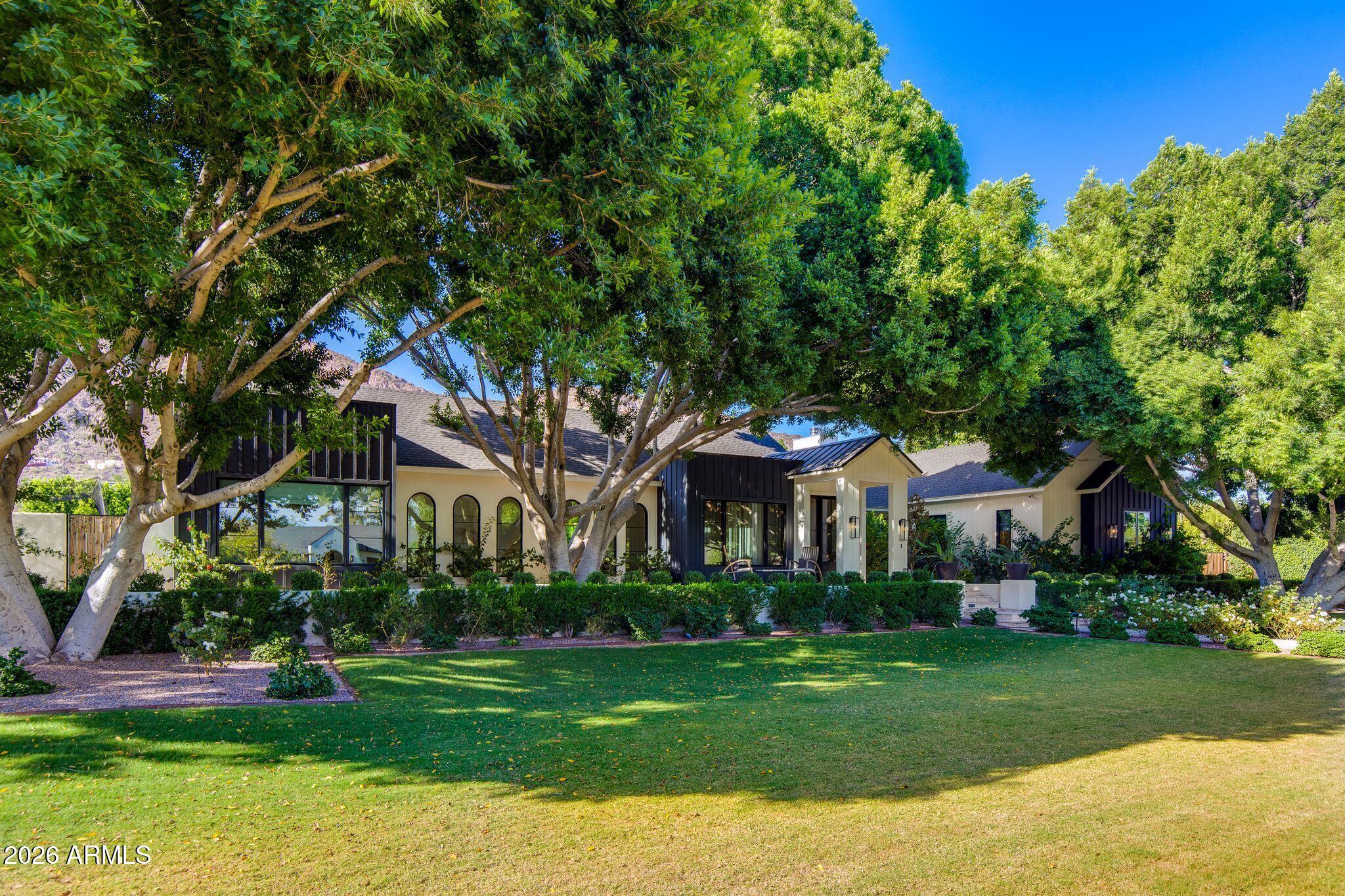 Situated within a prime cul-de-sac in the heart of Arcadia Proper, this extraordinary estate blends timeless luxury with exceptional design, all framed by lush mature landscaping and breathtaking Camelback Mountain views. Built in 2021, the single-level, open concept floor plan offers 5 bedrooms, 4.5 baths, and 5,800+ square feet of refined living space designed for both elevated entertaining and everyday comfort.  At the center of the home, the kitchen is beautifully appointed with premium appliances, an oversized island, custom cabinetry, gas cooking, and full back pantry. Multiple living and entertaining spaces flow effortlessly throughout the home, while the split floor plan offers a private primary retreat and flexible spaces ideal for a gym, office, media room, or playroom. The backyard is a true private oasis, featuring a heated pool and spa, sport court, built-in BBQ, fire features, large grassy areas, and mature landscaping that creates a serene resort-like setting beneath the backdrop of Camelback Mountain.
Additional highlights include a spacious 3-car garage, RV gate and parking, smart home features, and no interior steps. Located within the highly sought-after Hopi/Arcadia school district and moments from Arcadia's premier dining and shopping, this is luxury living at its finest in one of Phoenix's most desired neighborhoods.