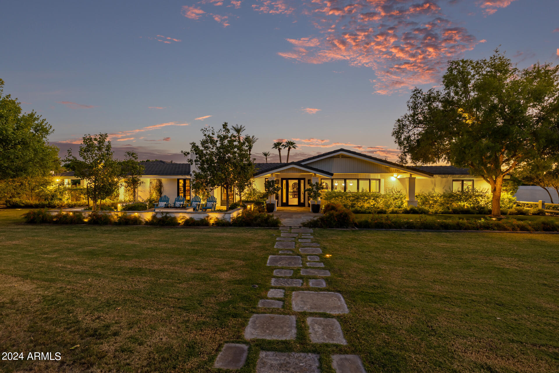 Nestled in the heart of Arcadia, with one of the most prestigious addresses in the entire Phoenix area! Completely remodeled by Arcadia Builders in 2016, this luxurious 5 bedroom, 4.5 bathroom estate in Phoenix, offers an impressive 5,215 sq. ft. of living space. This timeless farmhouse design exudes charm and sophistication with its expansive ranch-style architecture and breathtaking CAMELBACK MOUNTAIN views. Camelback Mountain hovers over you whether you are washing dishes in your kitchen or swimming in your backyard - the views of this iconic mountain are incredible from the privacy of your own property. Step inside to find a beautiful blend of tile and distressed white oak wood flooring throughout, creating a seamless flow between rooms. The spacious kitchen is a chef's dream, featuring a large island, breakfast bar, and a stunning mountain view framed by the large window over the sink. Two farm sinks, wainscoting, Sub Zero fridge/freezer, and a white Ilve Majestic European Oven complete the kitchen nicely. The family room is perfect for gathering, offering one of five cozy fireplaces found in this home. The primary suite is a private retreat with a walk-in closet and a full master bathroom complete with a separate shower and tub for ultimate relaxation. Step outside to the jewel of the property, the spacious backyard. Here you'll find an expansive covered patio, turf areas, sparkling pool, lighted pickleball court, basketball hoop, and a garden! This backyard oasis is perfect for entertaining or simply enjoying the Arizona sunshine. The property also features a DETACHED GUEST HOUSE, offering additional space and privacy for visitors. With a prime location close to shopping, dining, and top-rated schools, this home offers the best of luxury living in Phoenix's desirable Arcadia community. Don't miss the opportunity to make this exceptional home yours!