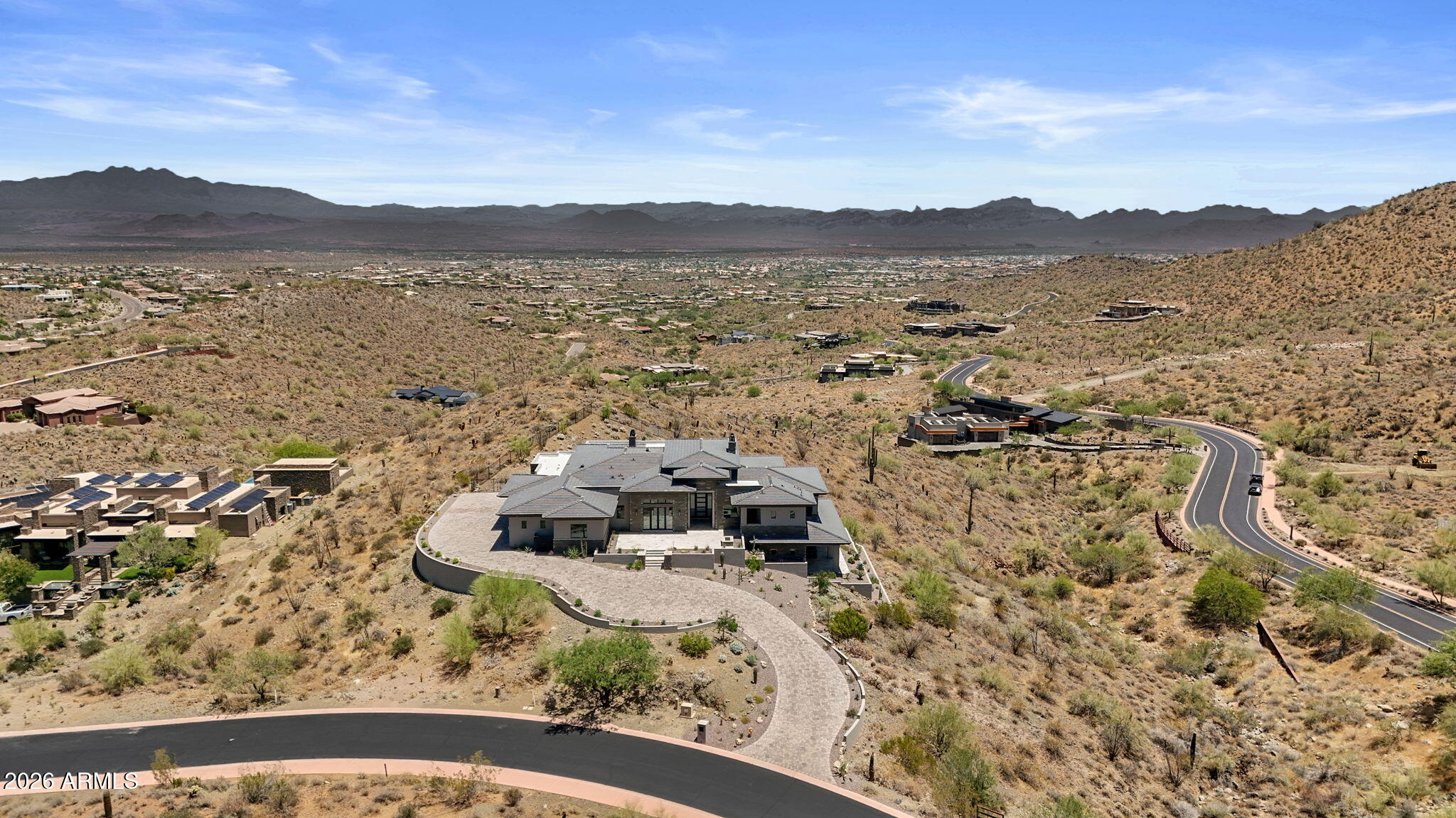 Experience elevated desert living at Eagles Nest with this exceptional new construction opportunity. Perfectly positioned on a large lot overlooking the Superstition Mountains, this contemporary residence captures sweeping mountain, city light, and Sonoran Desert views from nearly every angle. Thoughtfully designed for Arizona indoor/outdoor living, the home features expansive glass, open-concept living spaces, and seamless transitions to outdoor entertaining areas. Located within one of Fountain Hills' premier gated communities, the property offers privacy, stunning natural surroundings, and high-end new construction finishes, all while maximizing the panoramic views that make Eagles Nest so desirable.