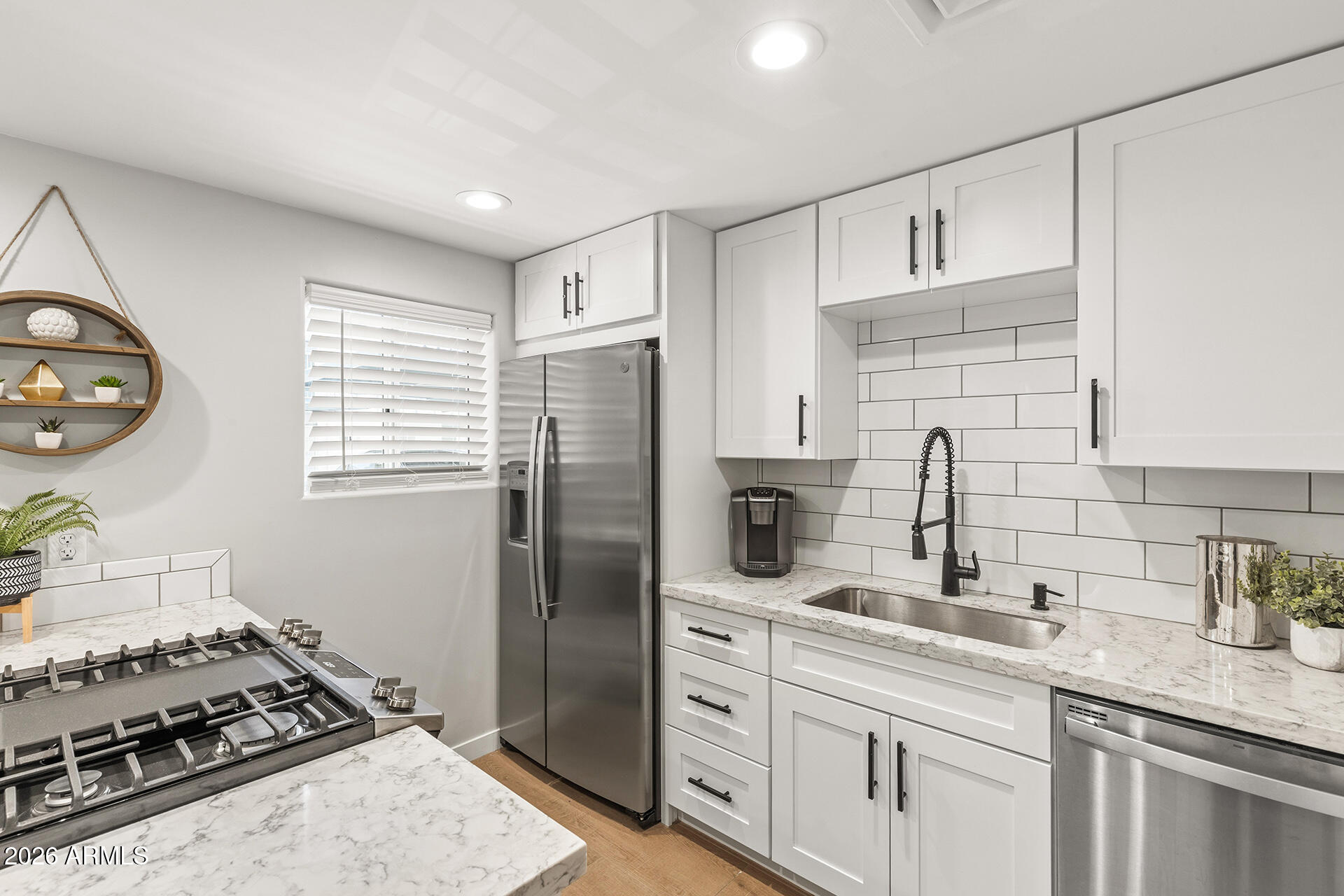 FULLY REMODELED & TURNKEY SCOTTSDALE CONDO WITH FURNITURE INCLUDED! Renovated down to the studs, this move-in ready condo offers modern finishes and an unbeatable location near Old Town Scottsdale and Arcadia. Major 2021 updates include HVAC, electrical, and plumbing. The kitchen features granite counters, subway tile backsplash, stainless steel appliances, and breakfast bar seating. The remodeled bath offers custom tile flooring, a large walk-in shower, abundant cabinetry, and great storage. Luxury wood-look tile runs throughout. Enjoy a private patio with remote-controlled shades and green space views. Community amenities include 2 pools, spa, lush landscaping, and covered parking. CAP Canal Trail across the street is perfect for walking/running or biking. Located with easy access to Old Town Scottsdale, Arcadia, Loop 101, Loop 202, plus endless nearby shopping, dining & entertainment.