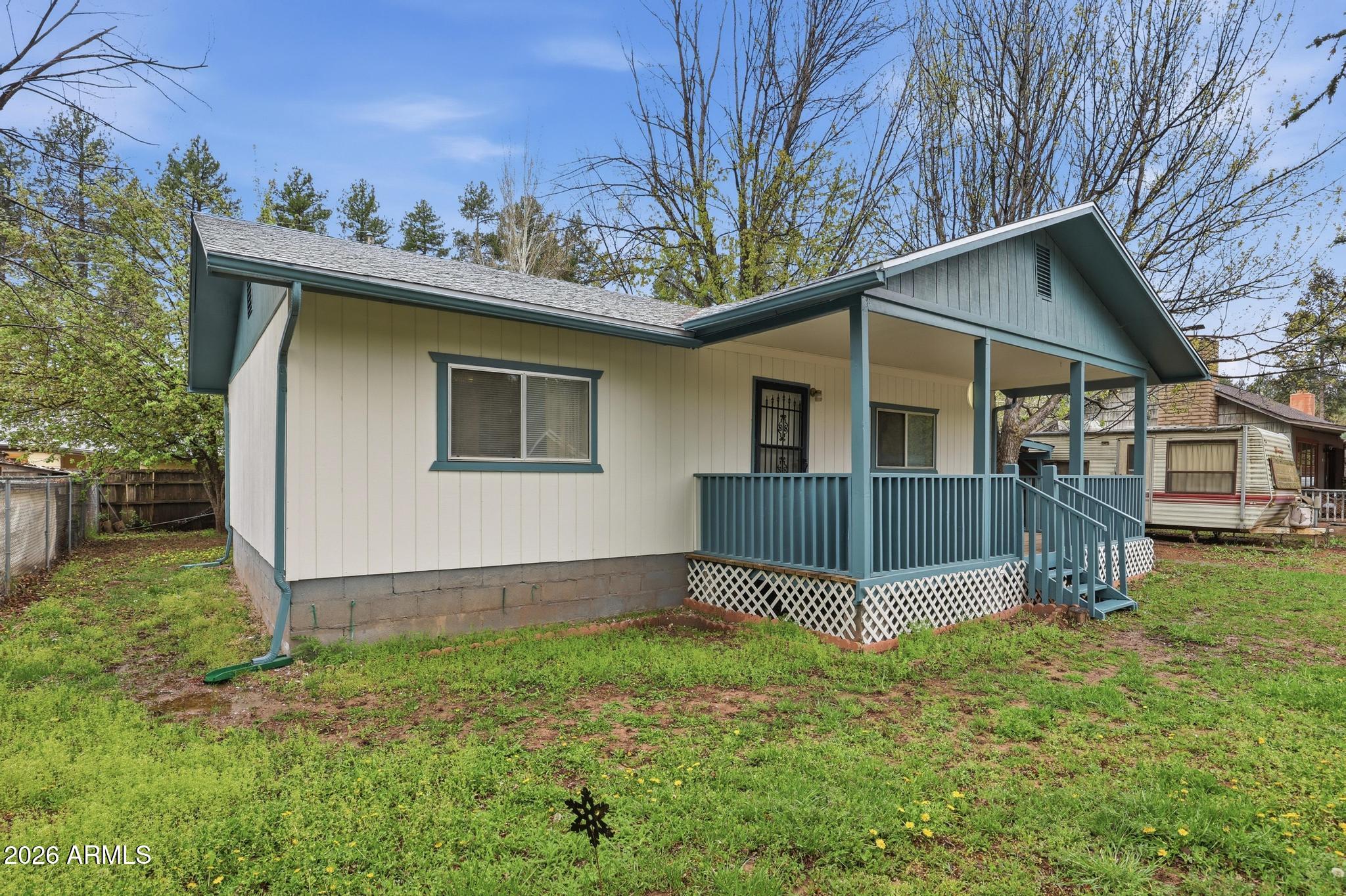 This is a great entry level escape to the pines, site built, single level home on a fully fenced lot with apple trees. Large front porch for relaxing, Living room is warmed by a gas wood stove, the spacious eat in kitchen with washer and dryer creates a functional and welcoming space. There are two comfortable bedrooms with plenty of storage and a separate bonus building that makes a great hobby space or extra sleeping area. There is an additional storage shed for your gear. The perfect spot for a simple, peaceful getaway in the pines.