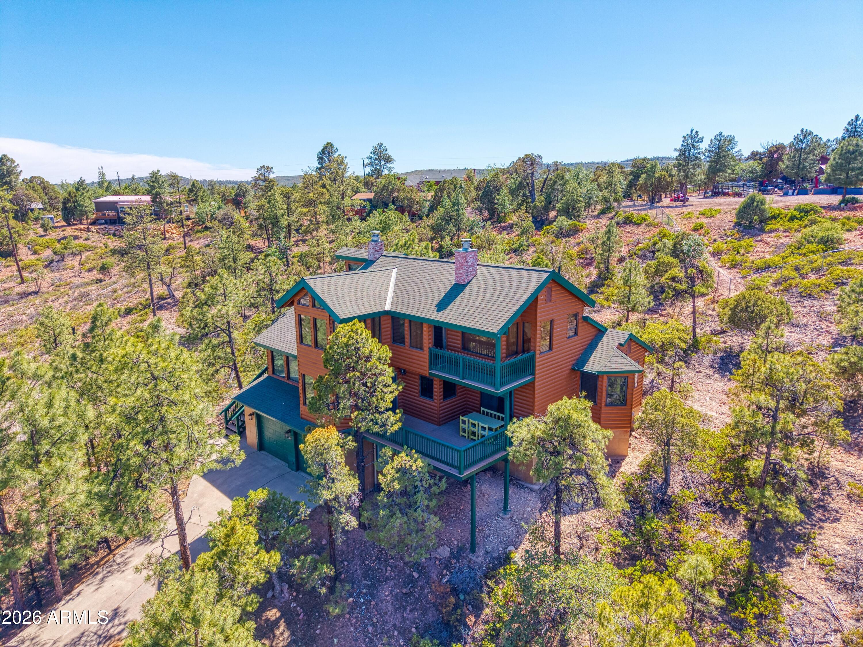 Tucked away among the whispering pines of Timberland Acres, this one-of-a-kind mountain retreat feels less like a house and more like a hidden story waiting to be discovered. Set on 1.06 serene acres, the home rises gracefully through the trees across three thoughtfully designed levels, blending warmth, character, and unforgettable views at every turn. Arrive through the peaceful woodland setting to a spacious two-car garage complete with additional storage and a convenient powder room -- perfect after a day spent exploring the outdoors. Upstairs, the heart of the home welcomes you to an open concept living room, custom oak cabinets throughout the chef desired kitchen, partial covered deck off the dining room. With two inviting bedrooms and 1.5 baths, where READ More!!!! ...where natural light pours through the windows and every room frames the beauty of the surrounding forest. But the true magic awaits on the third floor. The private primary suite is a retreat all its own -- perched among the treetops with a charming loft, a cozy wood-burning fireplace, and a balcony where mornings begin with birdsong and evenings end beneath a canopy of stars. Every corner of this home offers something unexpected, from its unique architectural charm to the peaceful connection with nature that surrounds it. Beautiful, distinctive, and impossible to duplicate, this Timberland Acres property is more than a home -- it's an experience waiting to be felt in person.