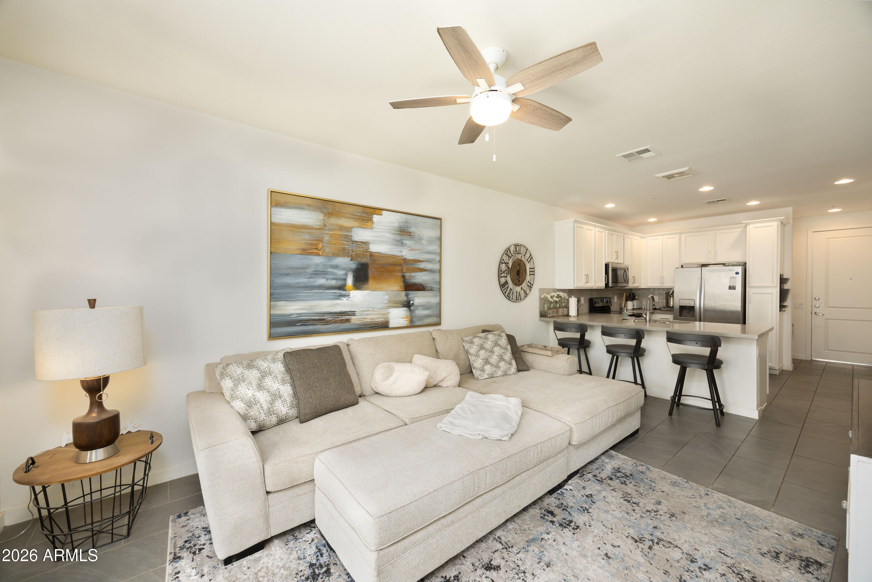 Beautiful condo with one of the best views in the community. This light and open floor plan features a spacious tiled great room, an open kitchen, and convenient in-unit laundry with washer, dryer, and refrigerator included. Thoughtfully designed with 1.5 baths for added functionality.

Perfectly positioned overlooking the resort-style pool and lounge area, the setting offers peaceful sunset views and a quiet atmosphere ideal for everyday living or a lock-and-leave lifestyle.

Additional features include secure underground parking with one assigned garage space.
Residents enjoy access to a full suite of resort-style amenities, including a heated pool and spa, BBQ areas, EV charging stations, clubhouse, fitness and yoga spaces, game and meeting rooms, and bike storage. Conveniently located near restaurants, coffee shops, wine bars, and scenic walking paths, this home offers the perfect blend of comfort, convenience, and lifestyle.

Offered fully furnished, making it an excellent option for a primary residence, second home, or investment property.
