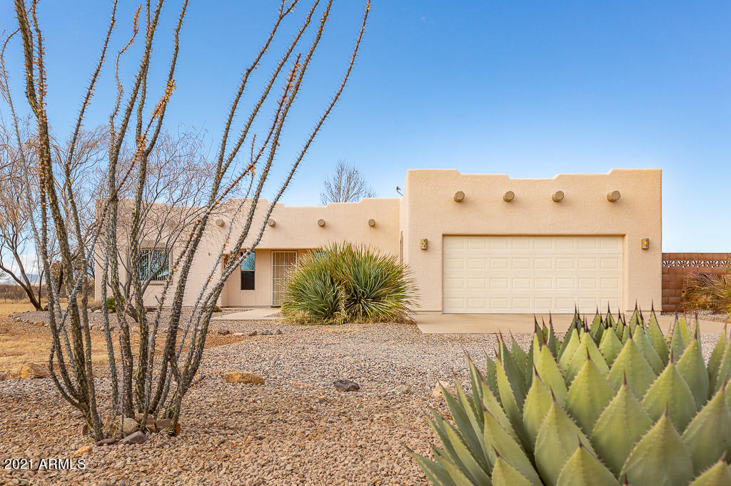 A Stargazer's dream!  Don't miss this meticulously maintained Santa Fe on four acres with panoramic mountain views.  This 3 bedroom, two bath gem features a split floor plan, with brand new tile work in the master bathroom.  Enjoy the beautifully landscaped yard with 1,000 water storage tank. Follow the sidewalk to your very own observatory with a roll-back roof for taking in those Arizona star-filled nights!  Don't miss this opportunity to enjoy the natural beauty, and peace and quiet of country living.  Call today for your private viewing!