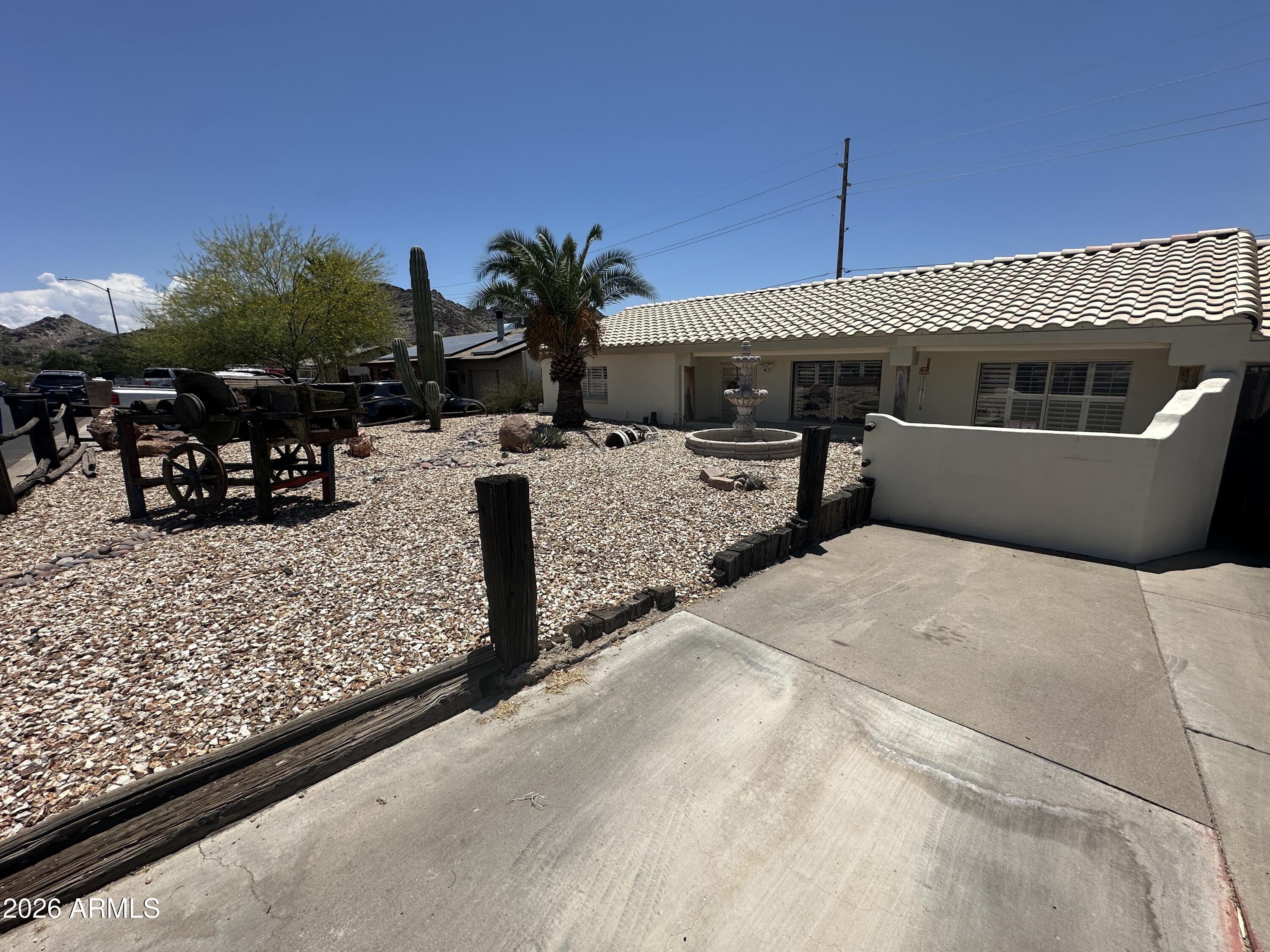 Nestled in a quiet Phoenix neighborhood with stunning mountain views, this home features custom touches throughout and a layout designed for comfort and entertaining. The spacious primary suite offers a private exit to the backyard retreat, where you'll find a unique outdoor shower for added privacy and relaxation. The kitchen is equipped with a gas range, multiple ovens, and granite countertops, making it ideal for cooking and gathering alike.