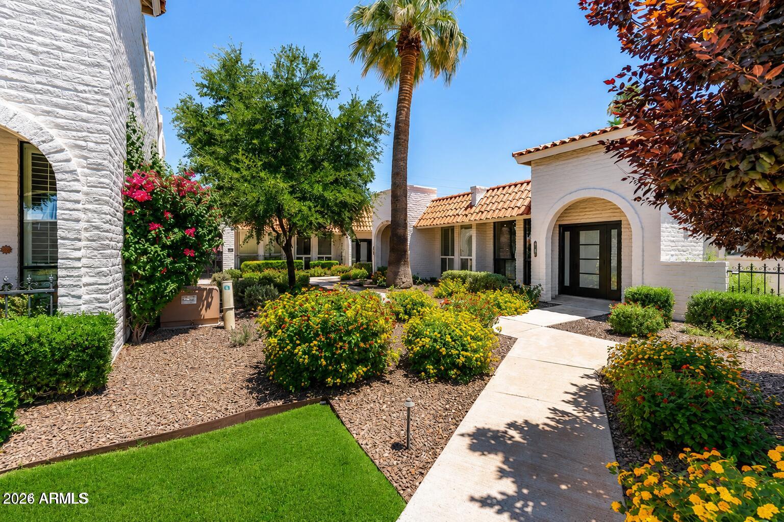 Welcome to your dream home in the heart of Paradise Valley! This newly renovated townhome is nestled in the charming community of Villa Serena. Step inside to discover a stunning open-concept floor plan bathed in natural light, high ceilings, new large windows and gorgeous new plank flooring. The brand-new gourmet kitchen features top-of-the-line stainless steel appliances, including Wolf gas cooktop, quartz countertops, and custom contemporary cabinetry, making it a chef's paradise.  Boasting  2 spacious bedrooms plus a den and 2 beautifully appointed bathrooms, this home is perfect for those seeking a serene and sophisticated lifestyle. Villa Serena offers a beautiful pool and spa with Camelback views as well as a clubhouse and fitness area. Walking distance to restaurants and shopping.